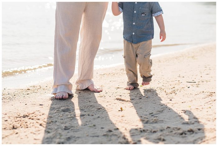 closeup of father and son barefoot on the beach