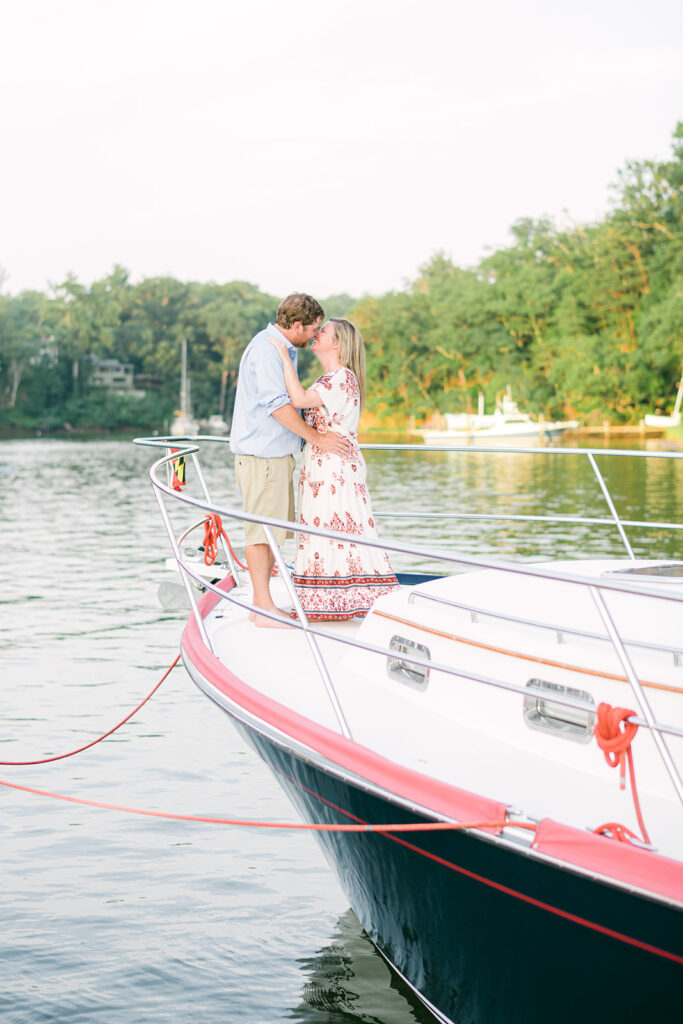 portrait of an engaged couple kissing on a boat