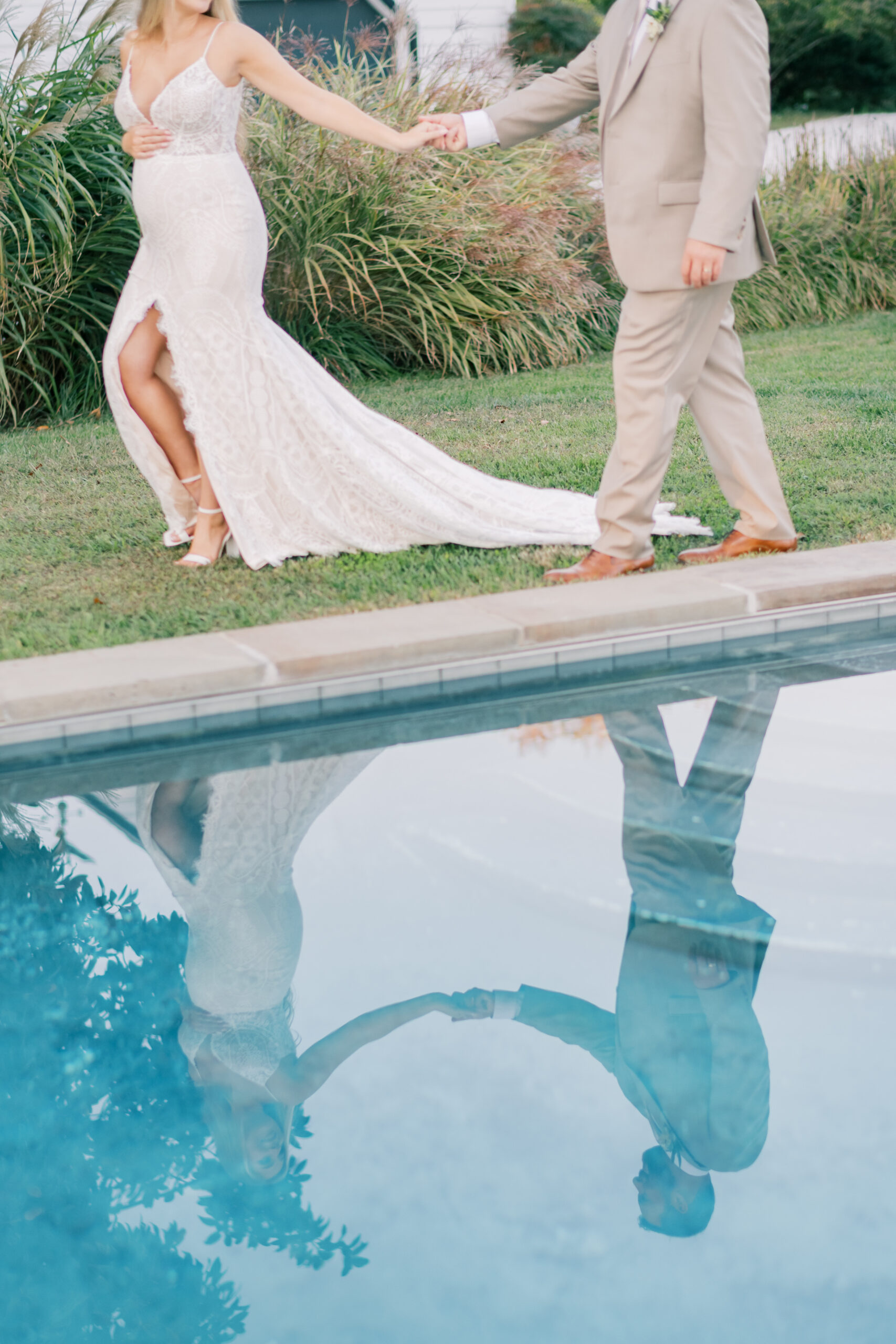 bride walks with groom along side of pool in Southern Maryland