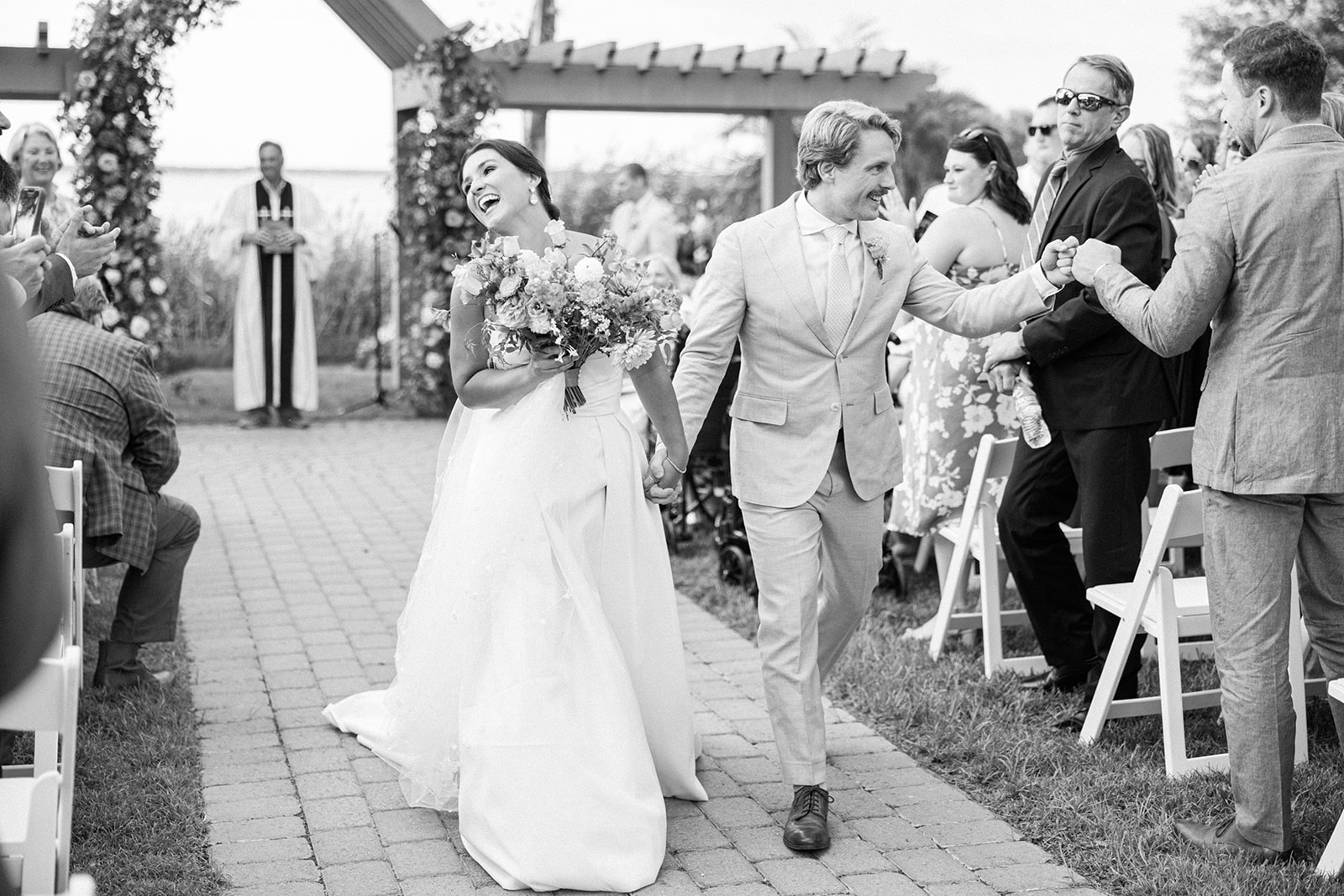 bride and groom cheer walking up aisle after ceremony at Herrington on the Bay