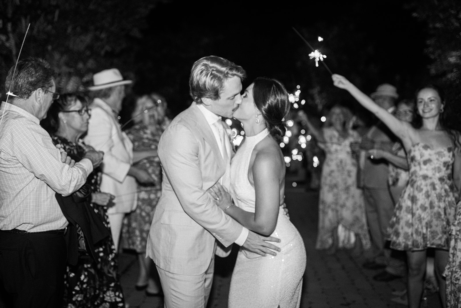 bride and groom kiss during sparkler exit from North Beach Maryland wedding reception