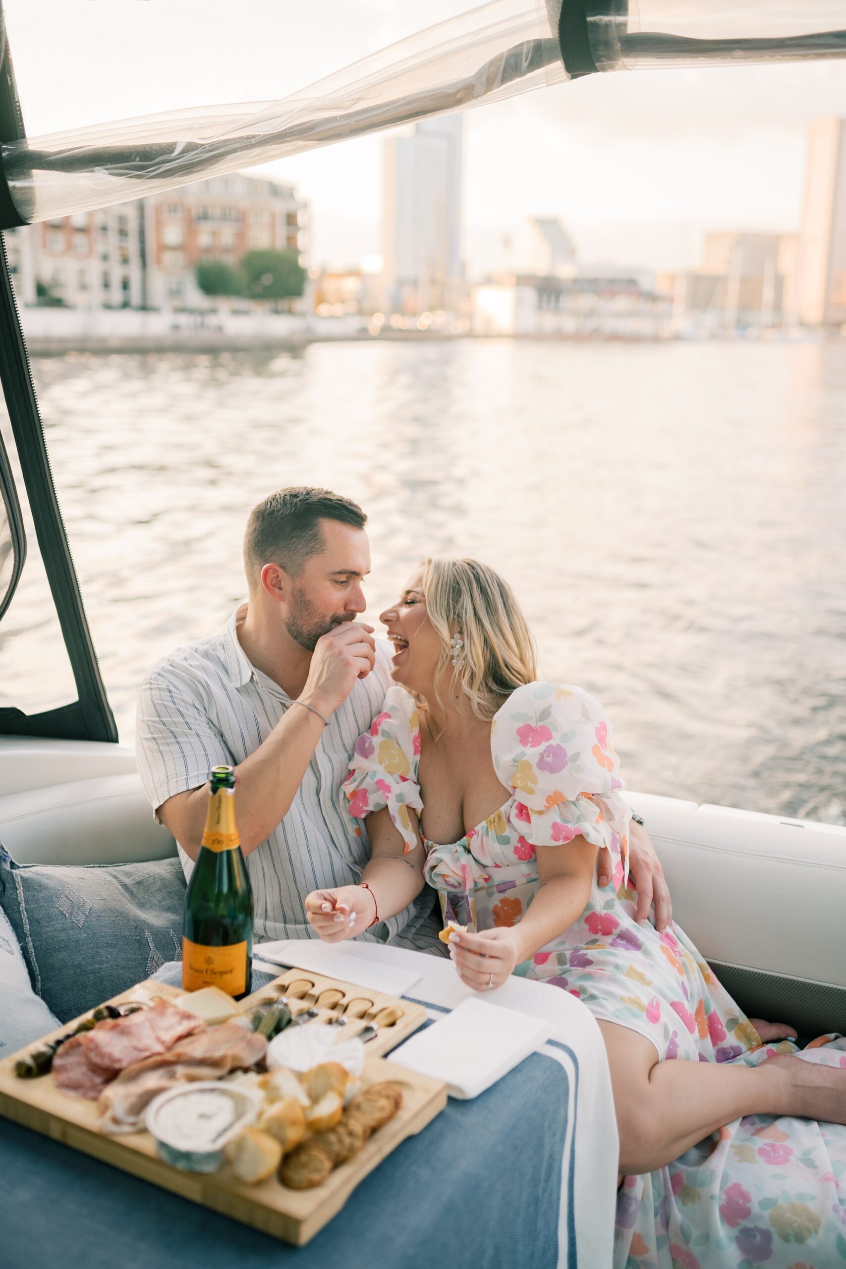 engaged couple eats from charcuterie spread on boat