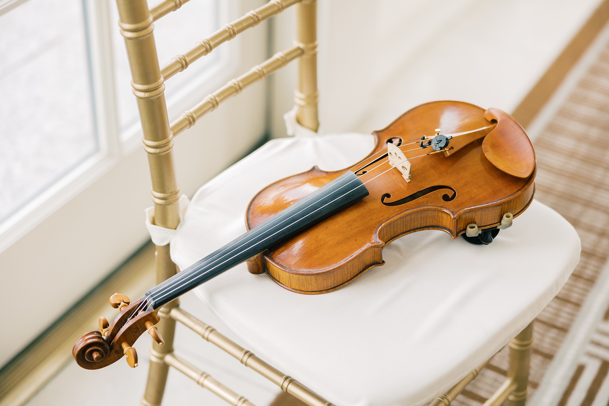 violin sits on chair before DC wedding day