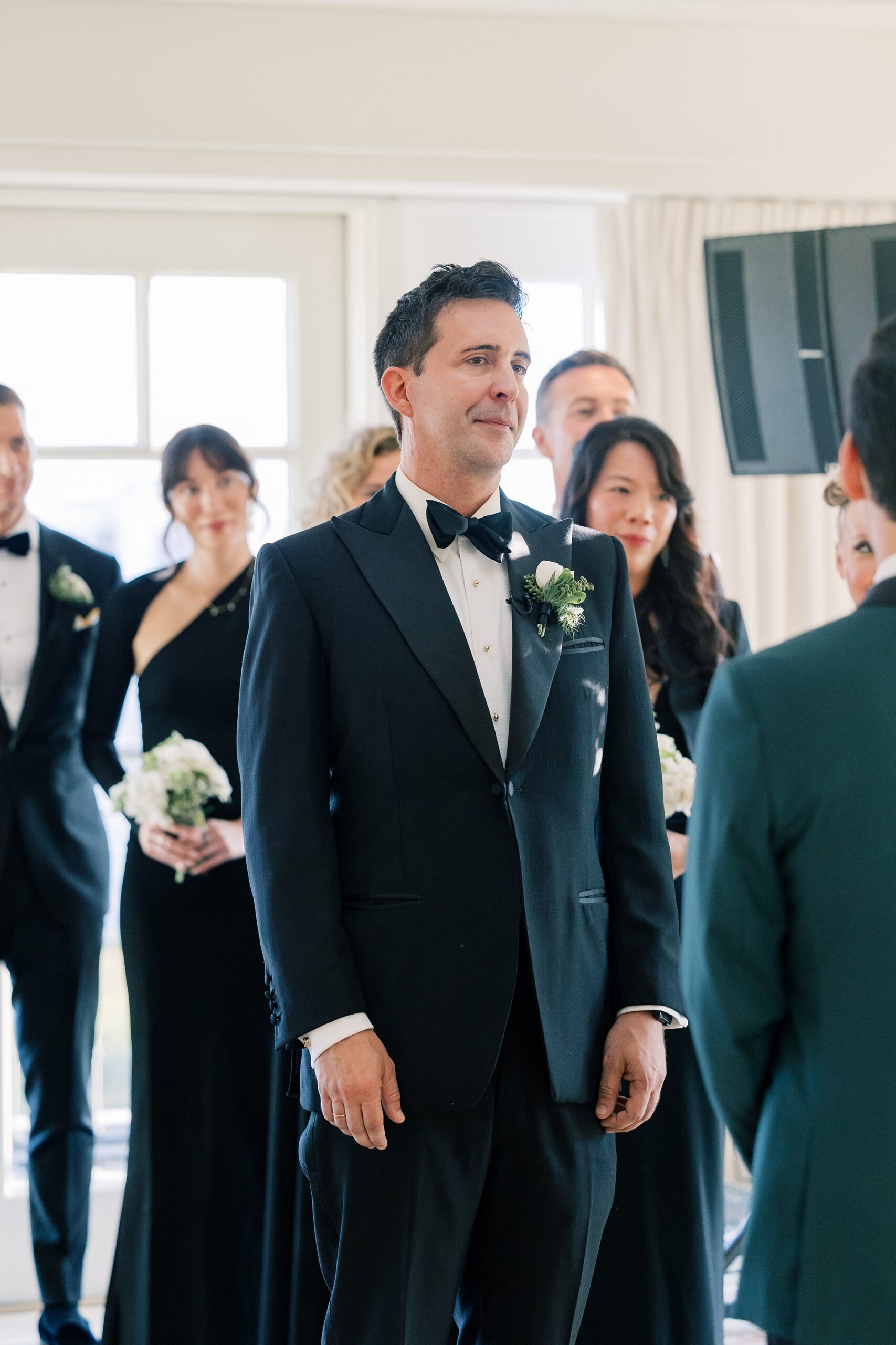 groom stands listening to vows during ceremony at the Hay Adams Hotel