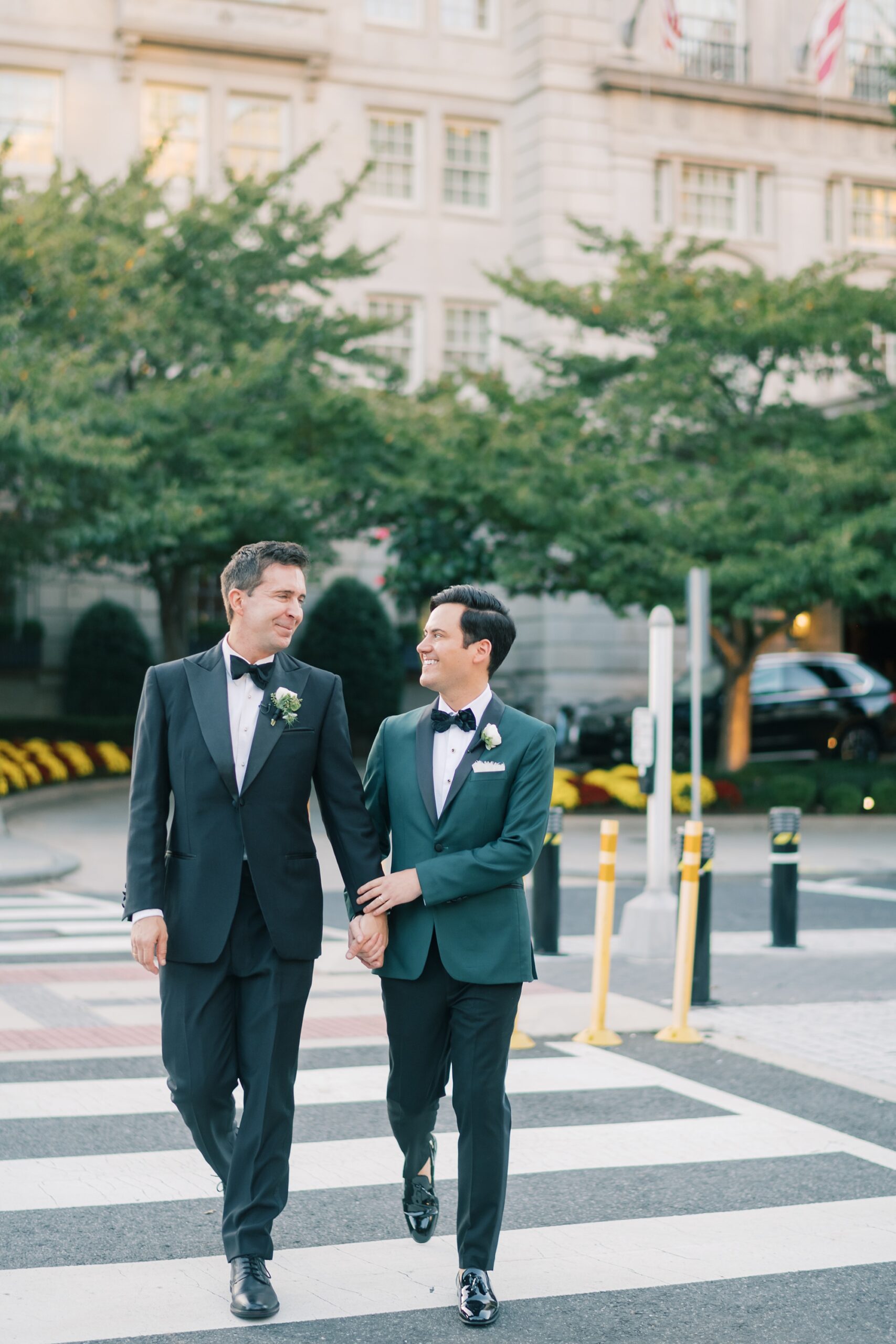 husbands hold hands walking on street in Washington DC