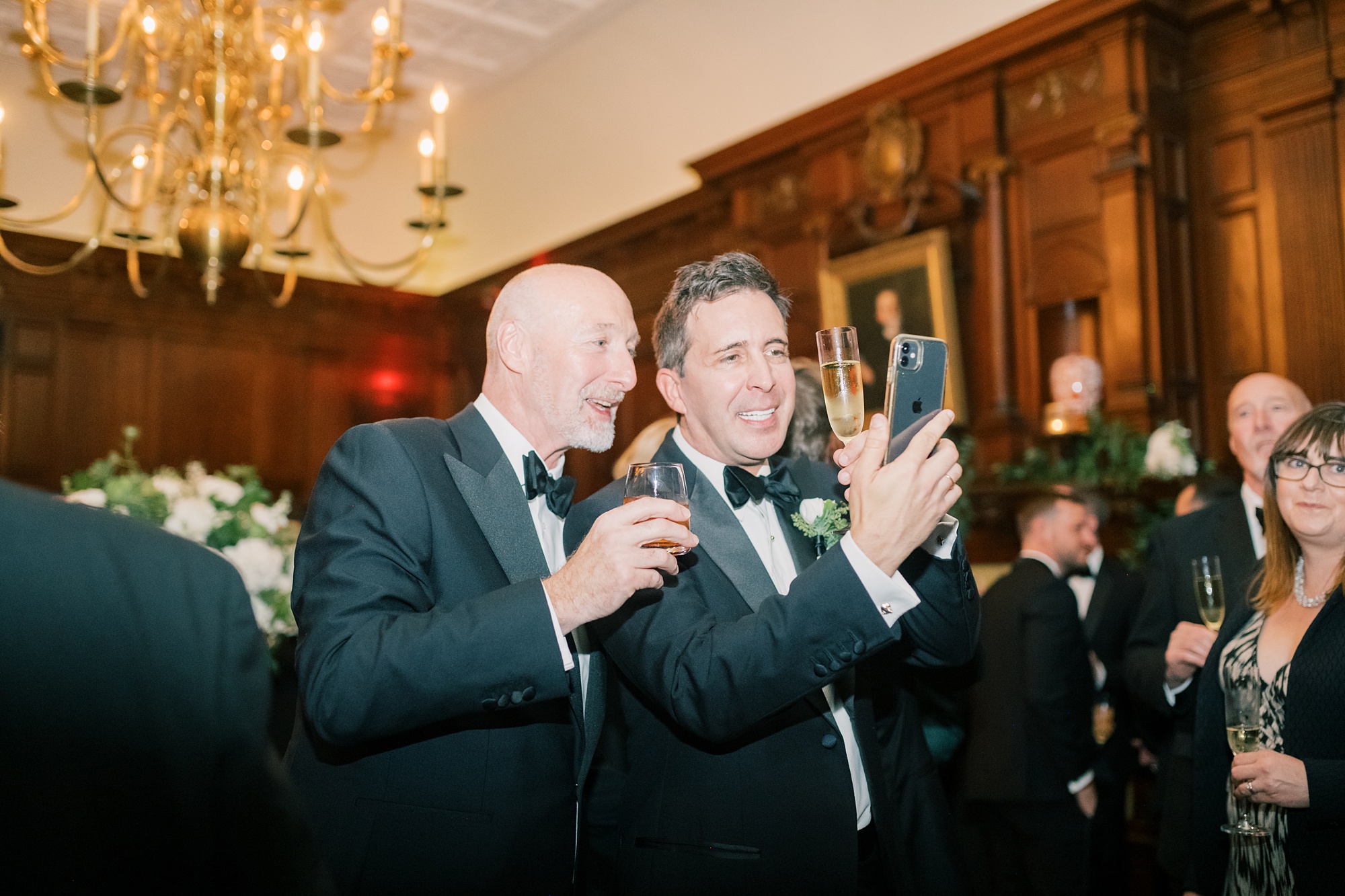 guests look at phone during cocktail hour at the Hay Adams Hotel