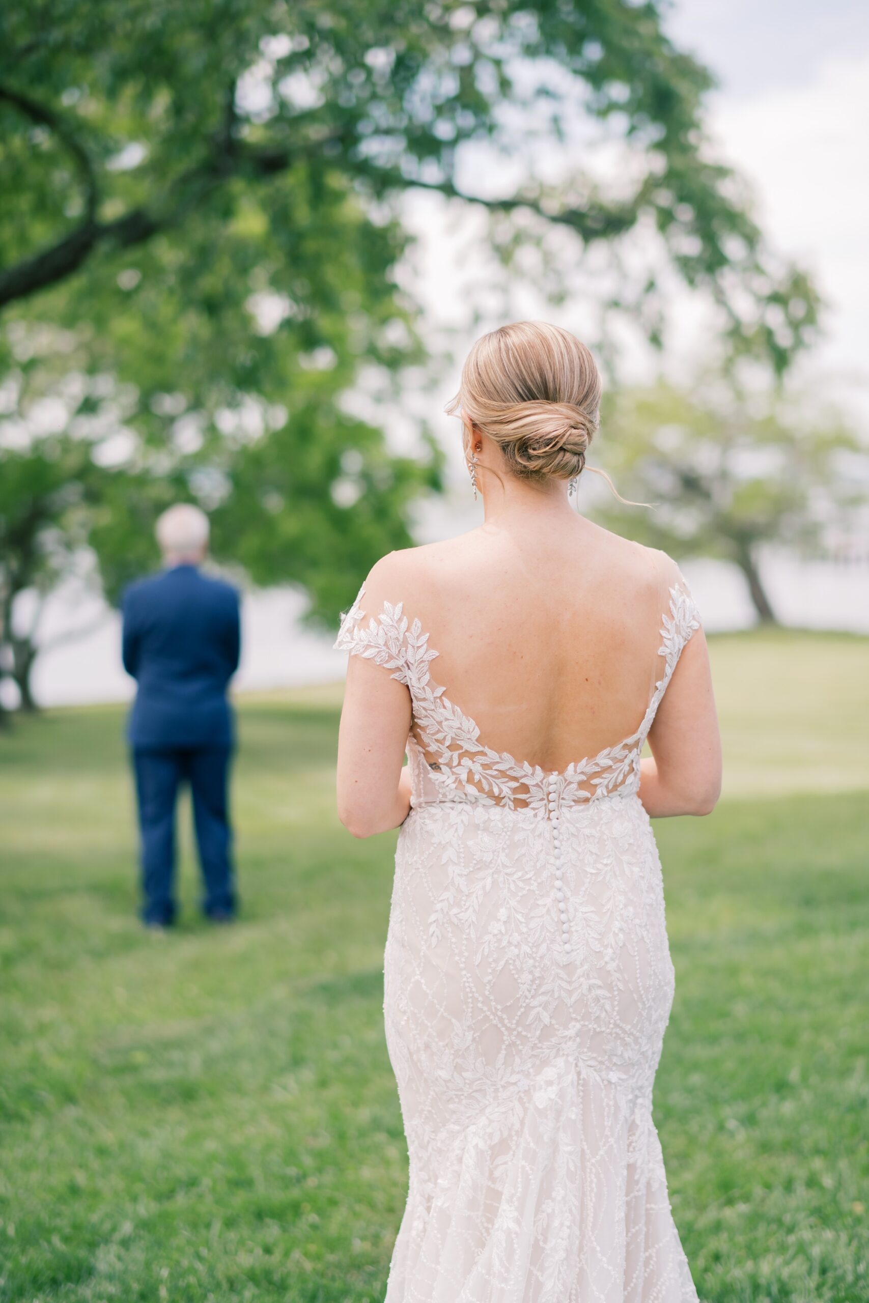 bride approaches dad under tree for first look at the Pavilion at Weatherly