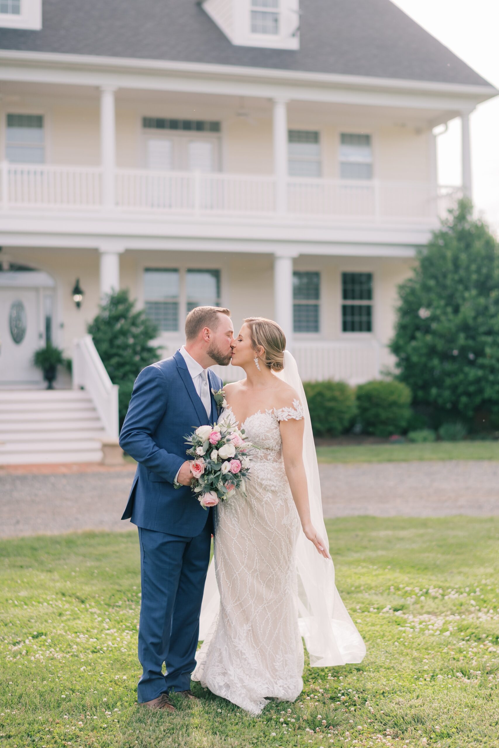 newlyweds kiss on lawn at the Pavilion at Weatherly