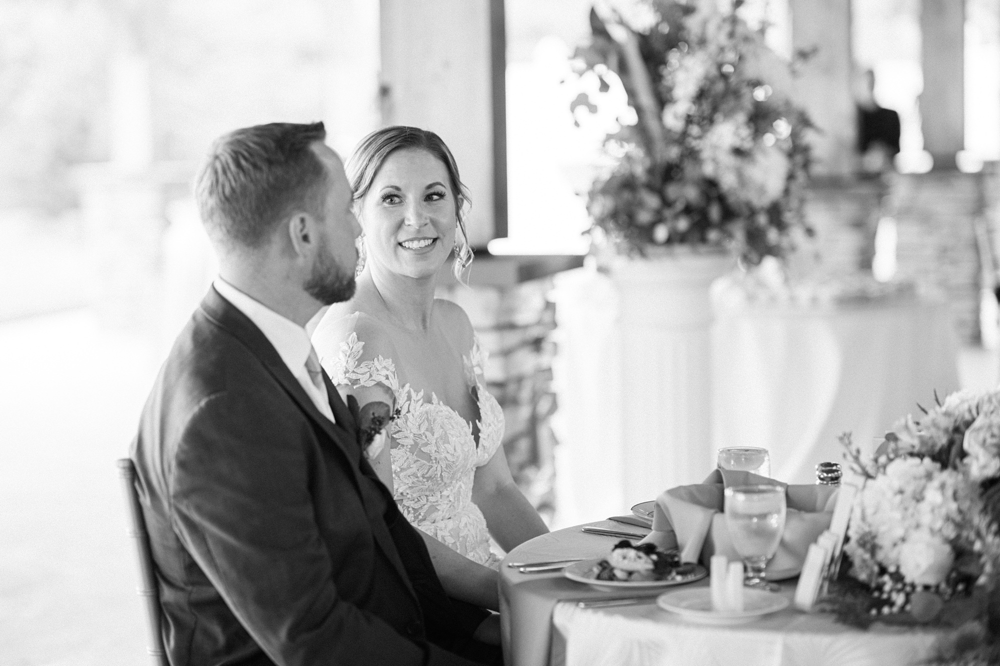 bride and groom listen to toasts during Maryland wedding reception 