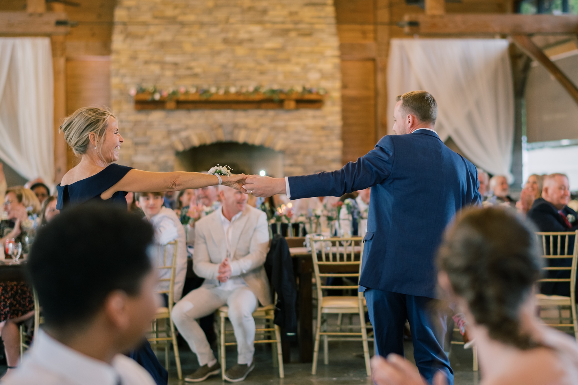 groom twirls mother during wedding reception at the Pavilion at Weatherly
