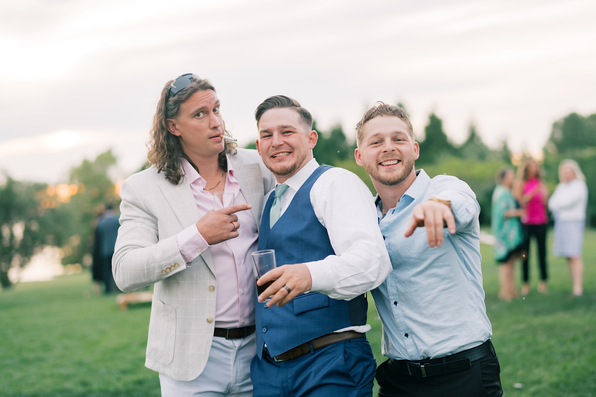 groomsman and guests pose with funny faces during Maryland wedding reception 