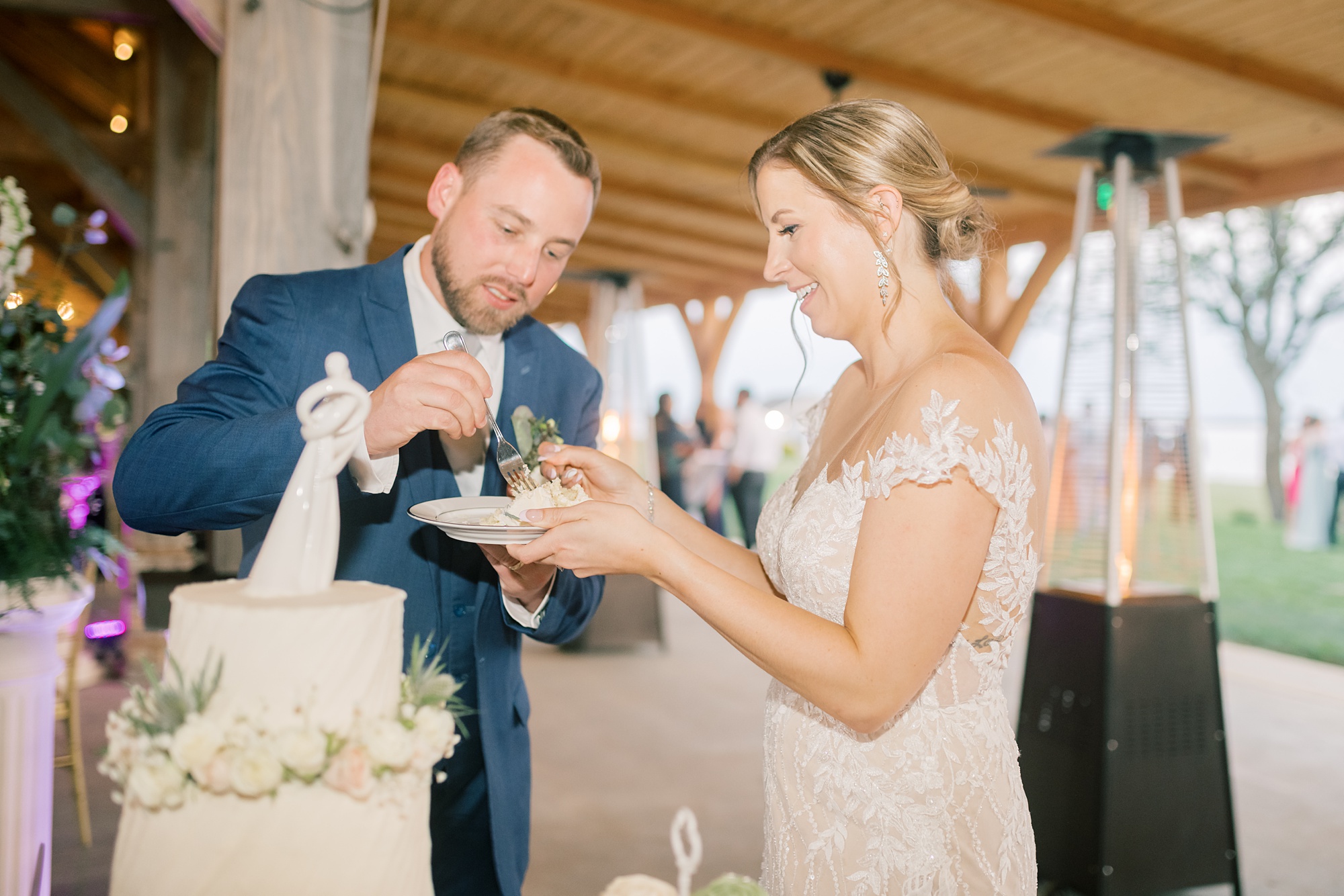 newlyweds cut wedding cake during the Pavilion at Weatherly wedding reception 