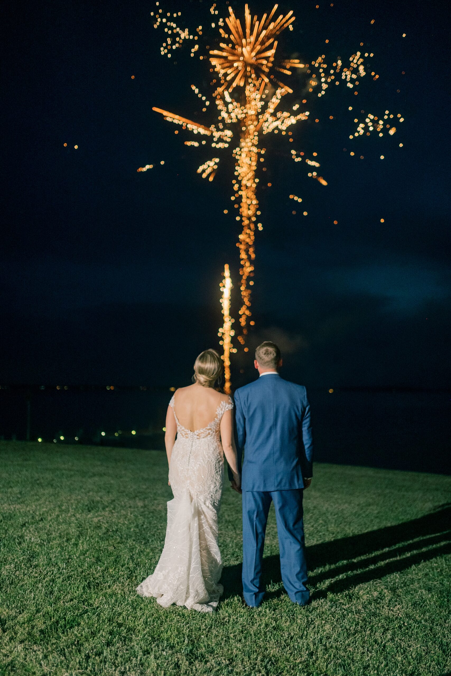 bride and groom look at fireworks during wedding at the Pavilion at Weatherly