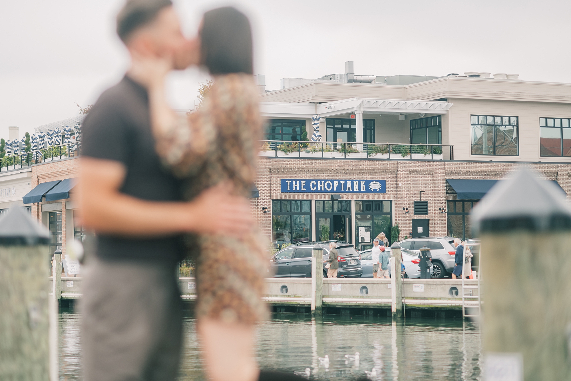 couple kisses during proposal in downtown Annapolis