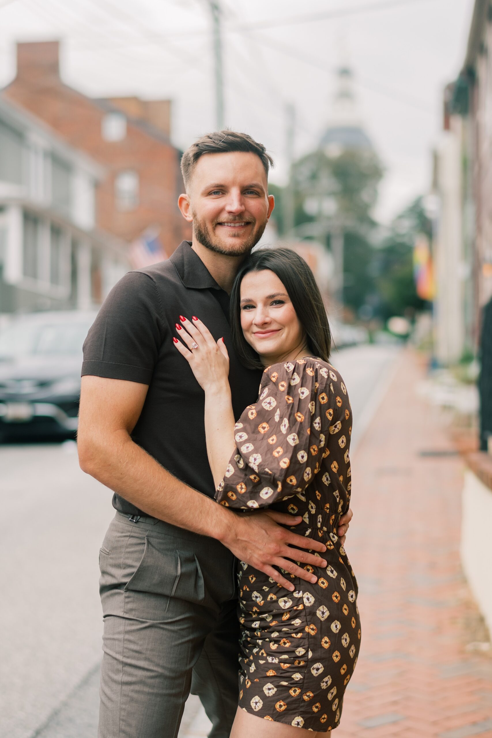 man and woman hug on street in Downtown Annapolis