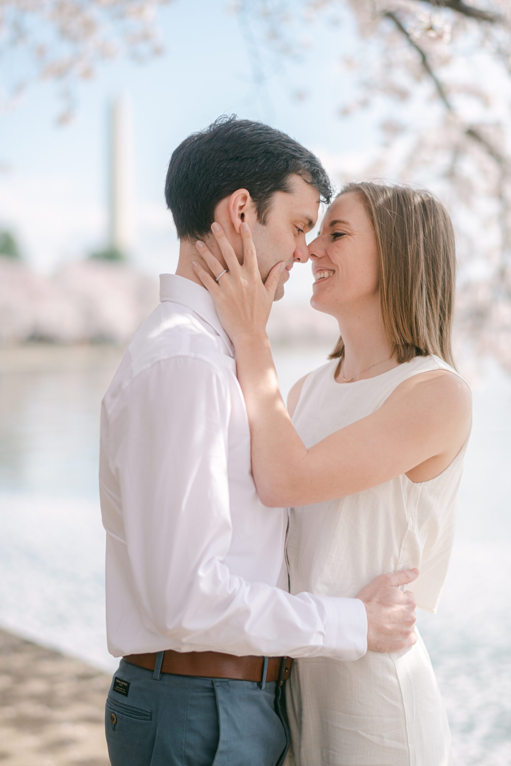 man and woman lean together nuzzling noses during DC engagement session