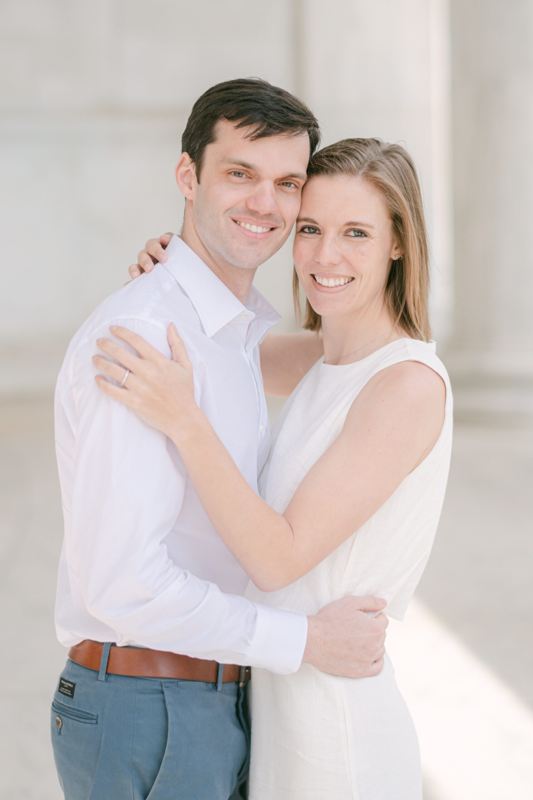 couple leans heads together during DC engagement session at Jefferson Memorial 