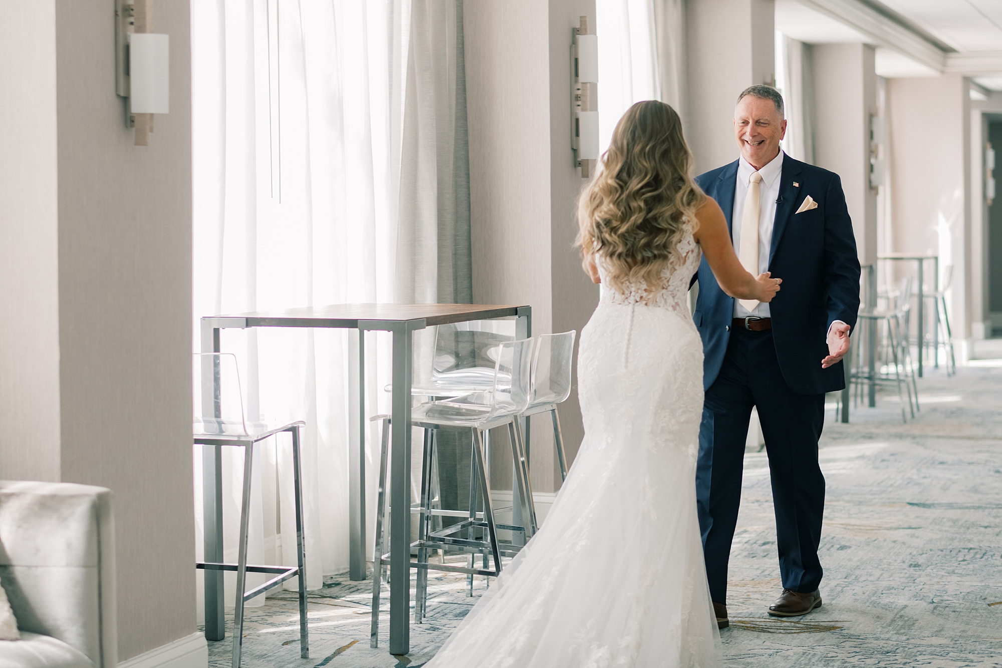 bride shows gown to father during first look in Washington DC