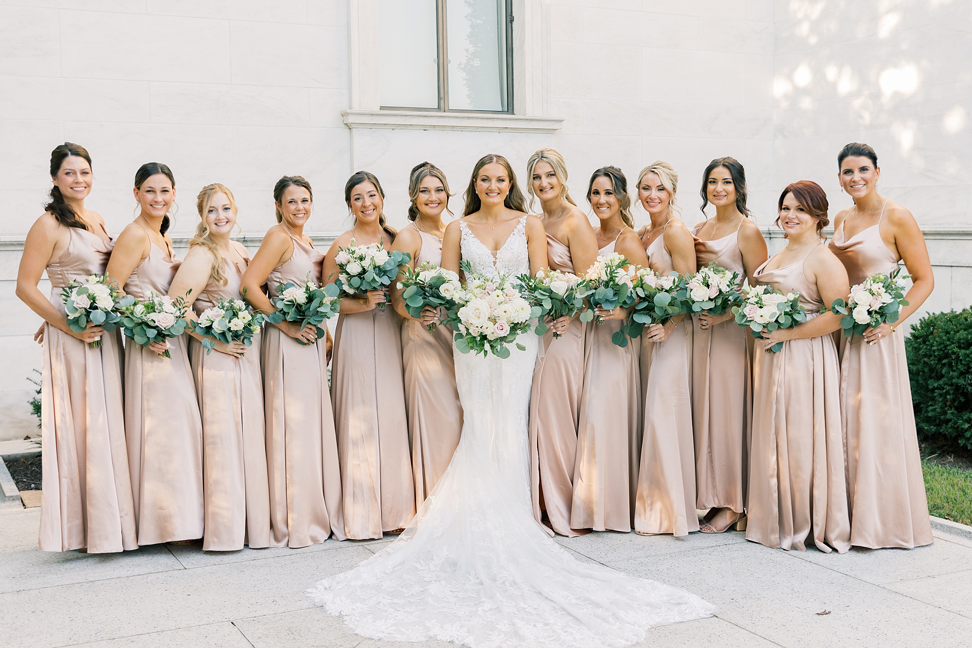 bride poses with bridesmaids in champagne gowns in Washington DC