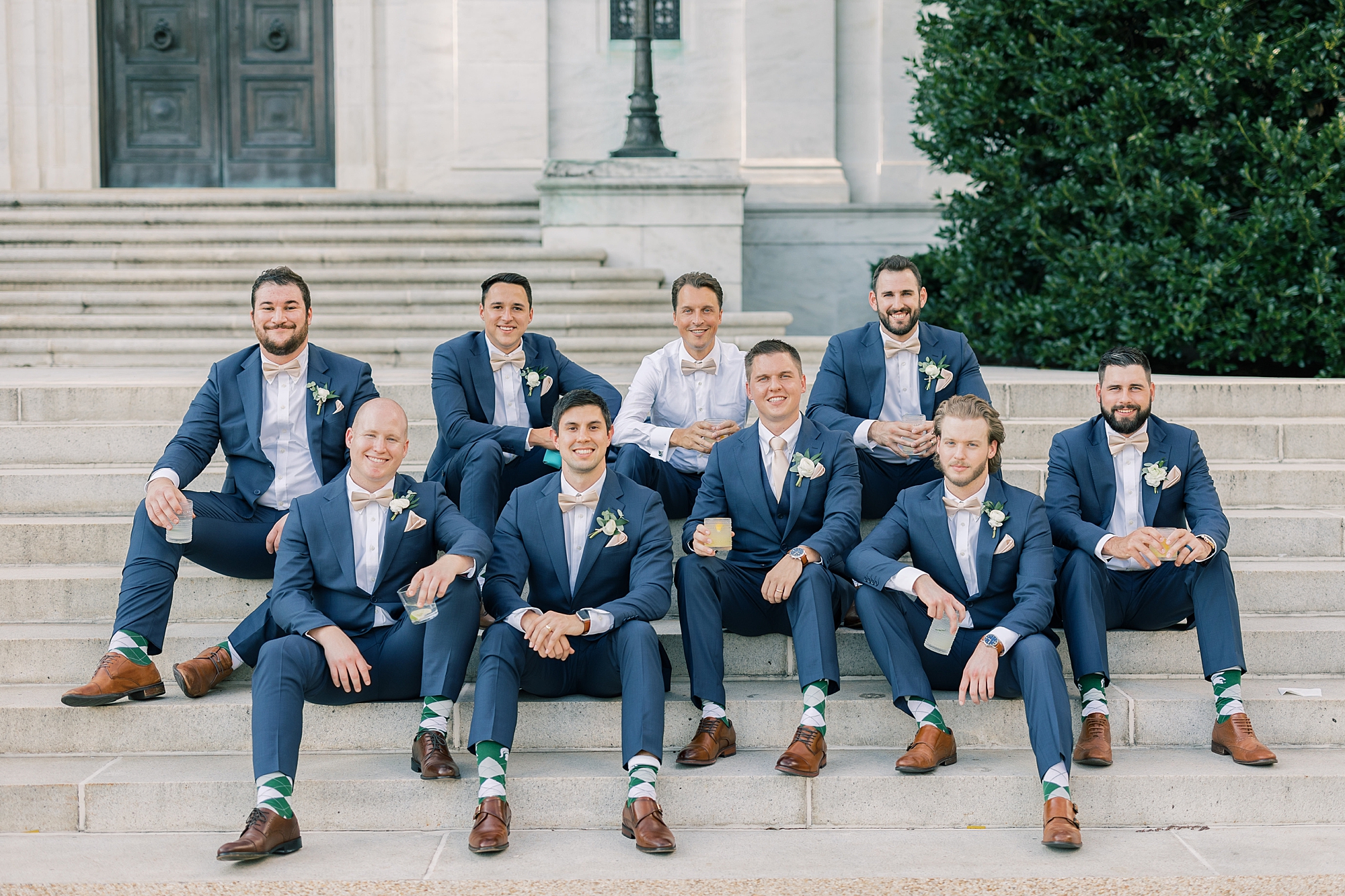 groom and groomsmen sit on steps of Potomac View Terrace in Washington DC