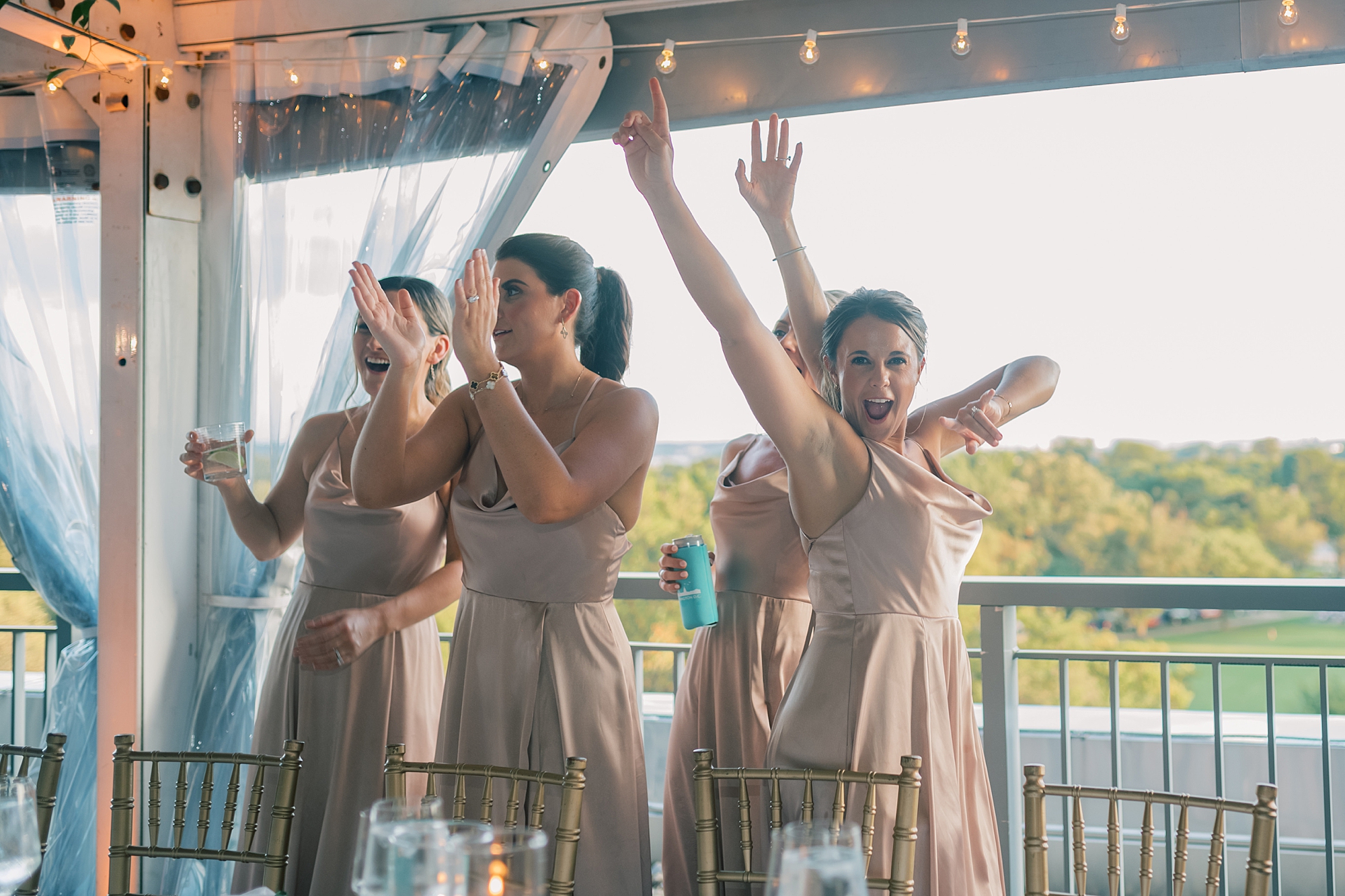 bridesmaids dance at their seats at Potomac View Terrace