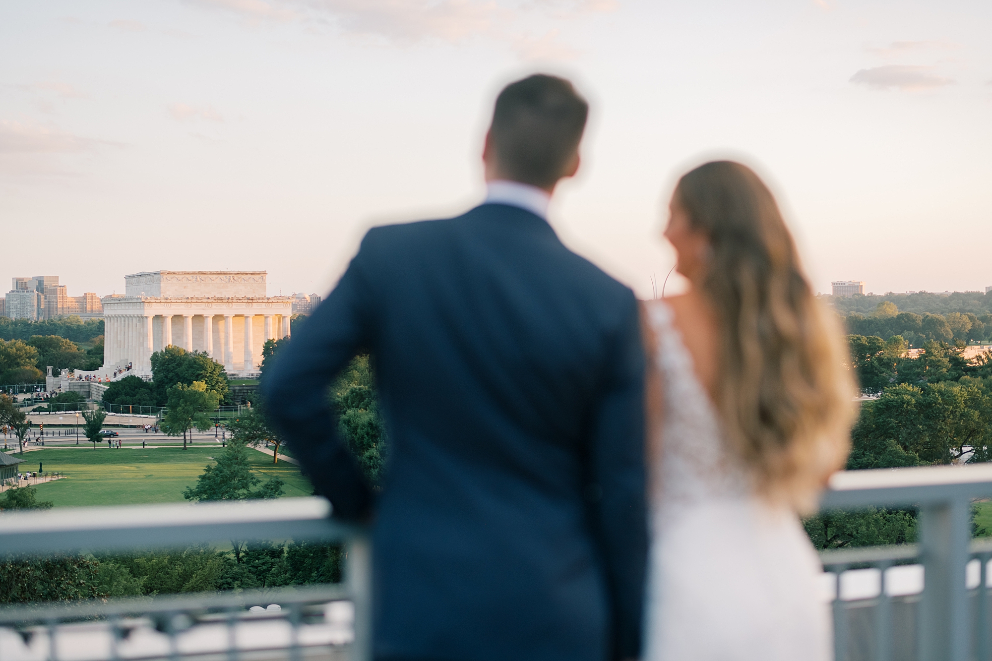 bride and groom look at DC from balcony at Potomac View Terrace