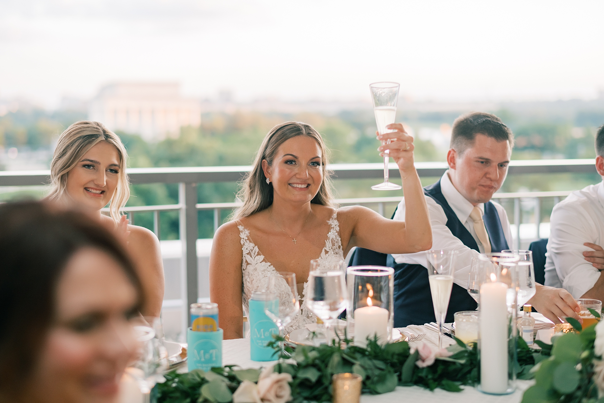 bride lifts glass in a toast during DC wedding reception at Potomac View Terrace