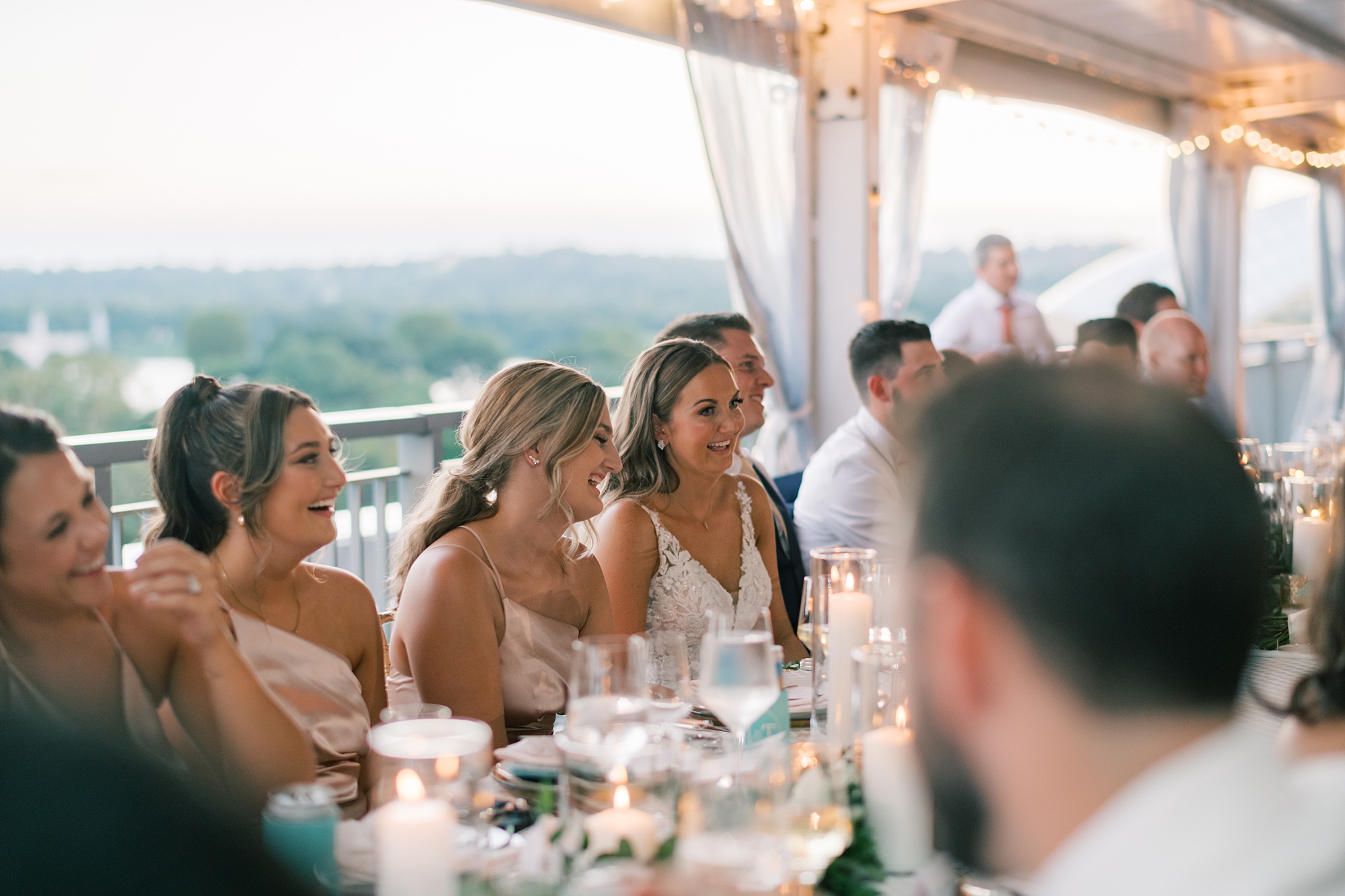 bride and groom listen to toasts on balcony at Potomac View Terrace