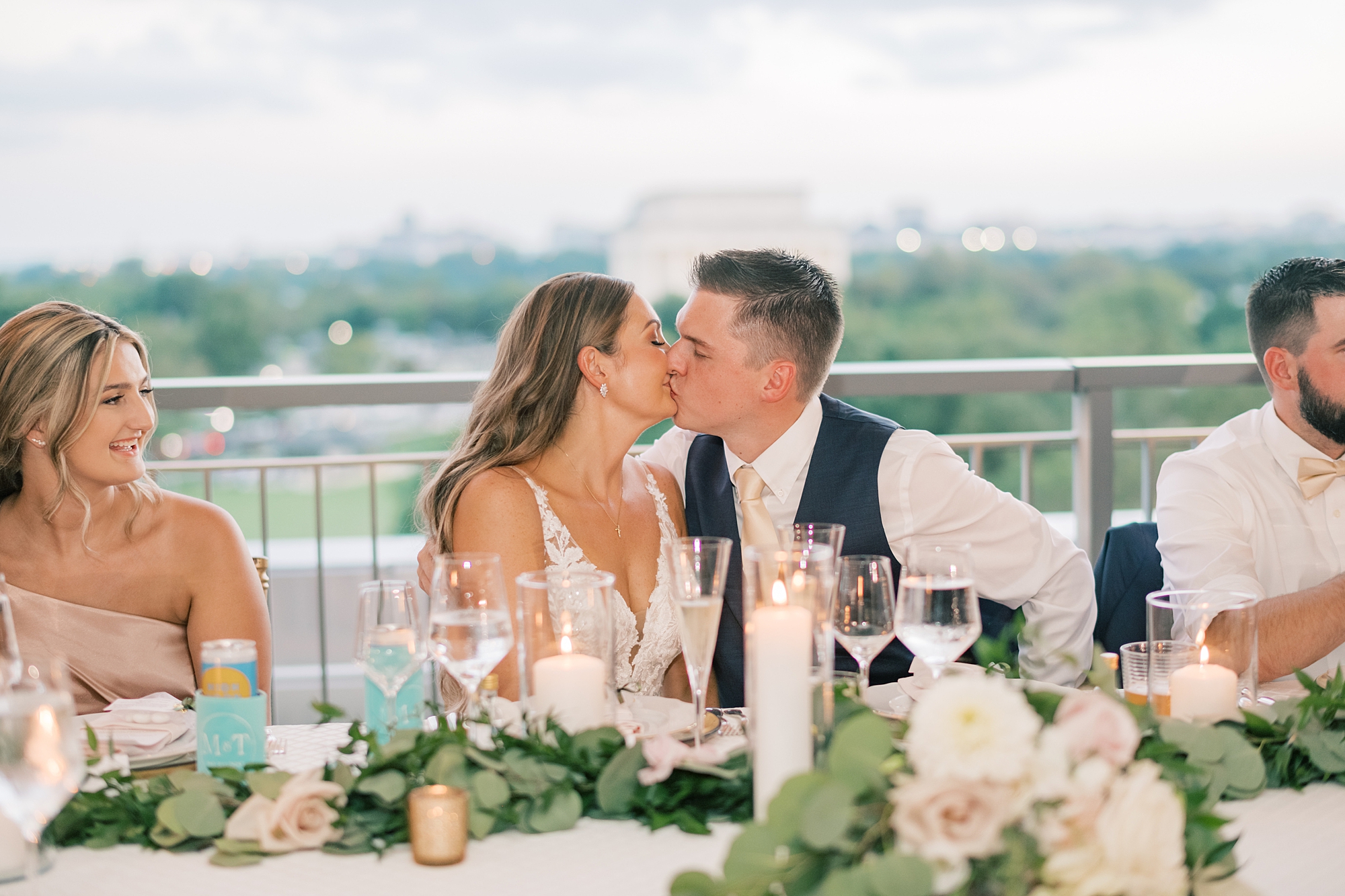 newlyweds kiss at head table at Potomac View Terrace