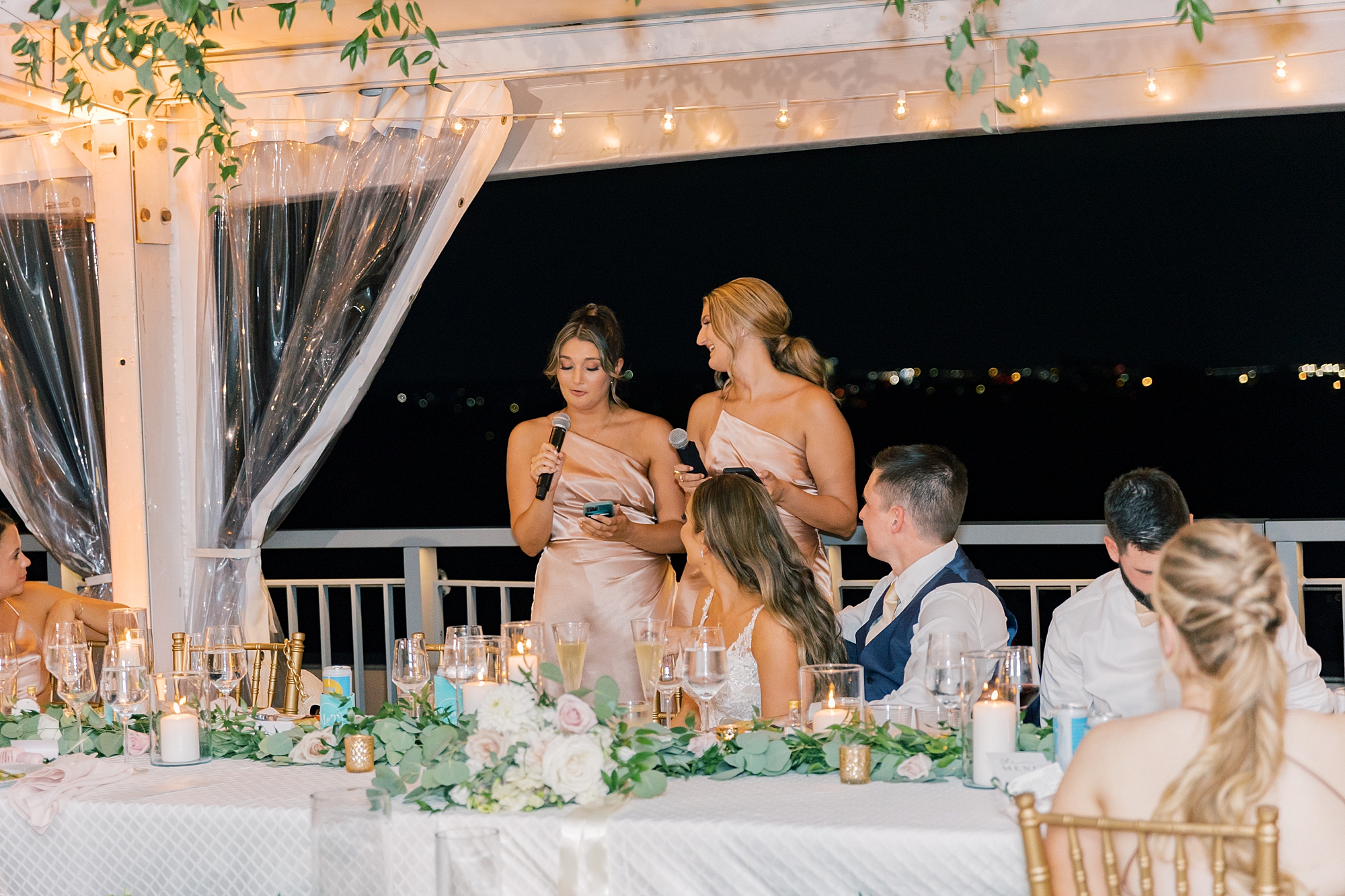 bridesmaids give speech to newlyweds on patio at Potomac View Terrace