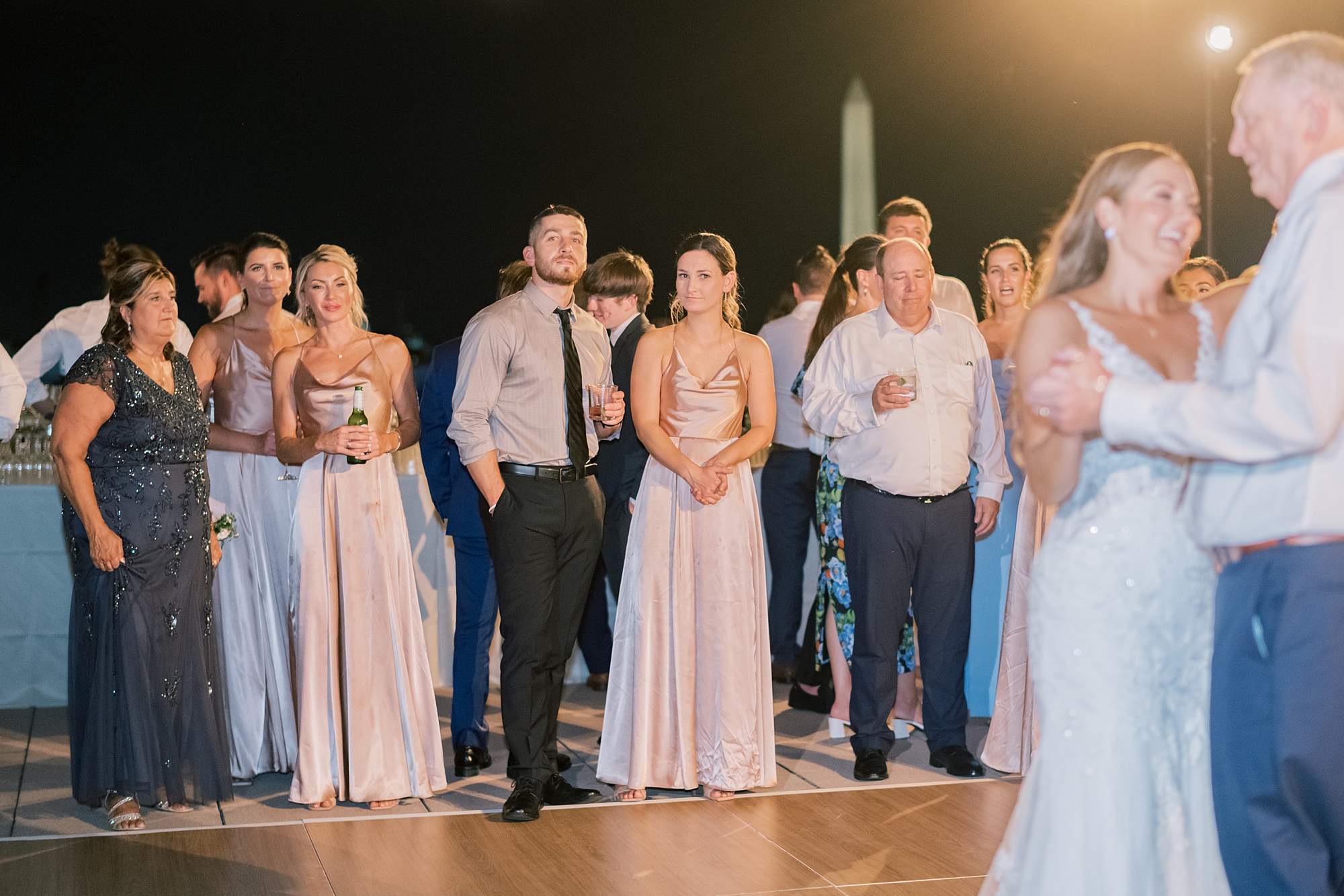 guests watch bride and groom dance during Potomac View Terrace wedding reception