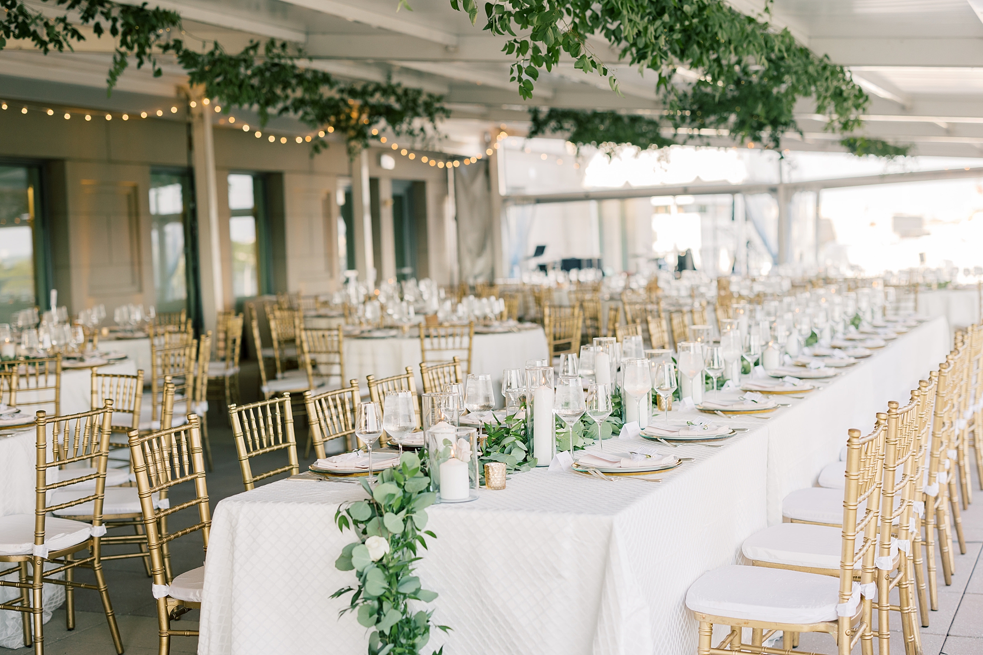 Potomac View Terrace wedding reception with greenery lining tables 