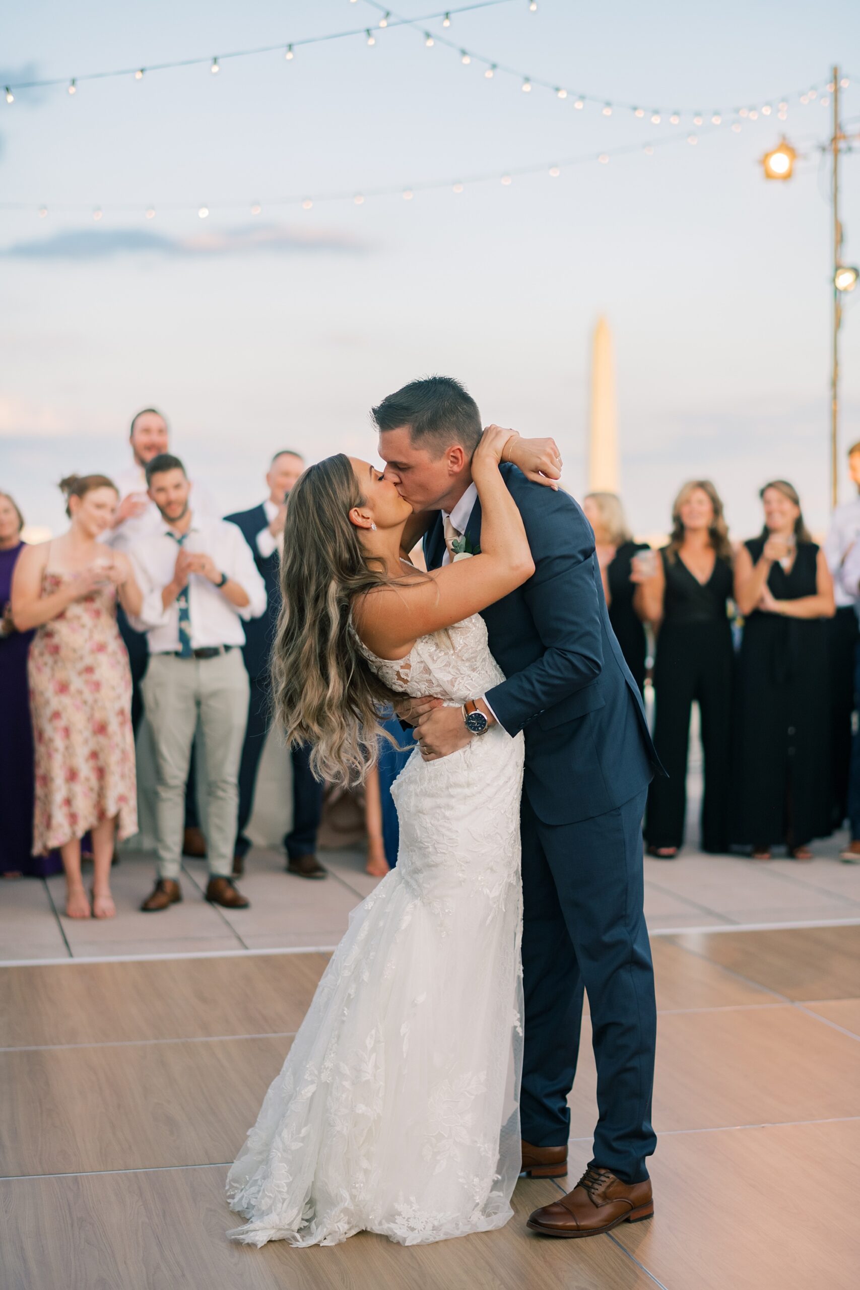 newlyweds kiss during first dance on patio at Potomac View Terrace