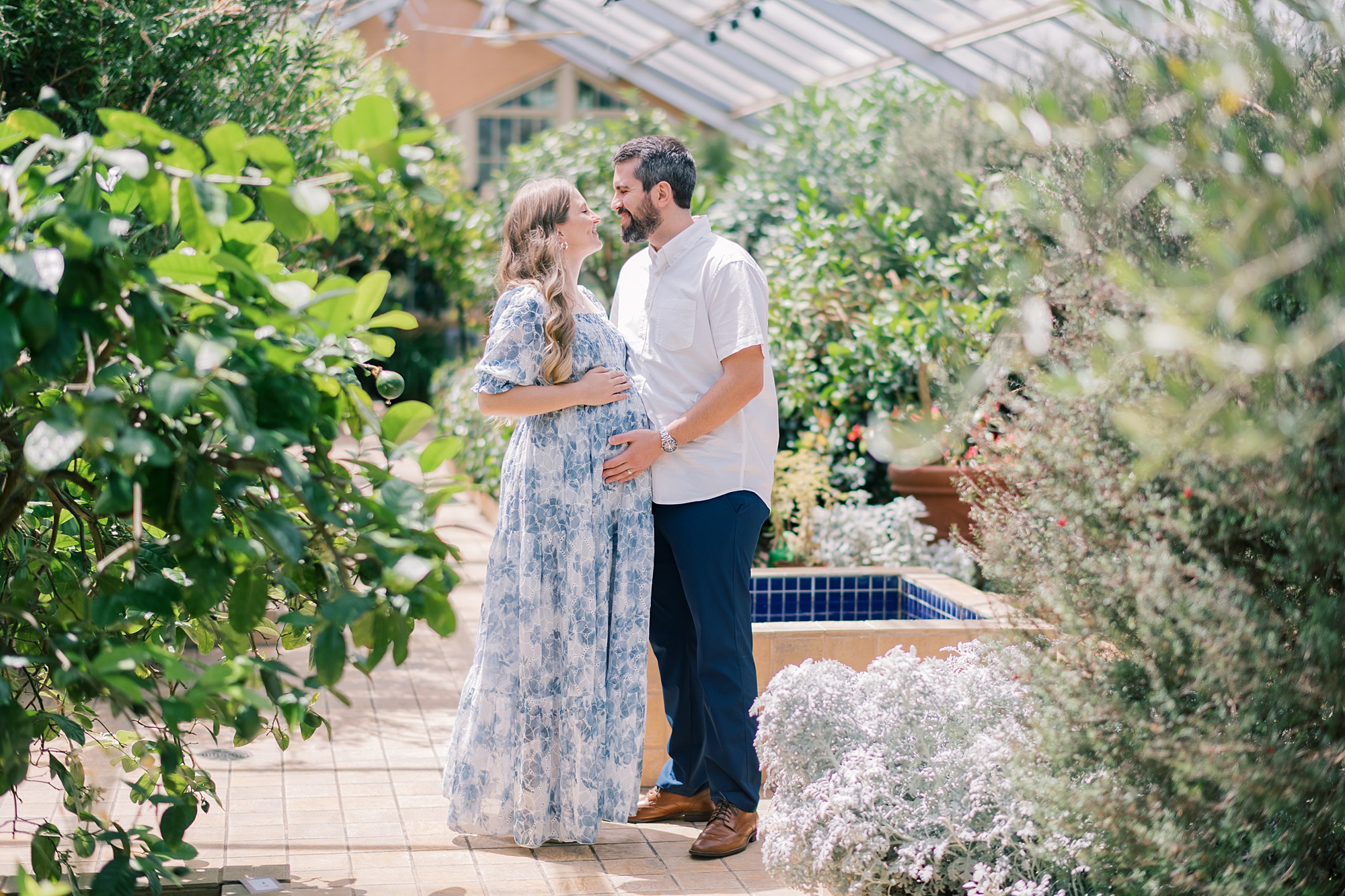 married couple hugs inside greenhouse at Rawlings Conservatory