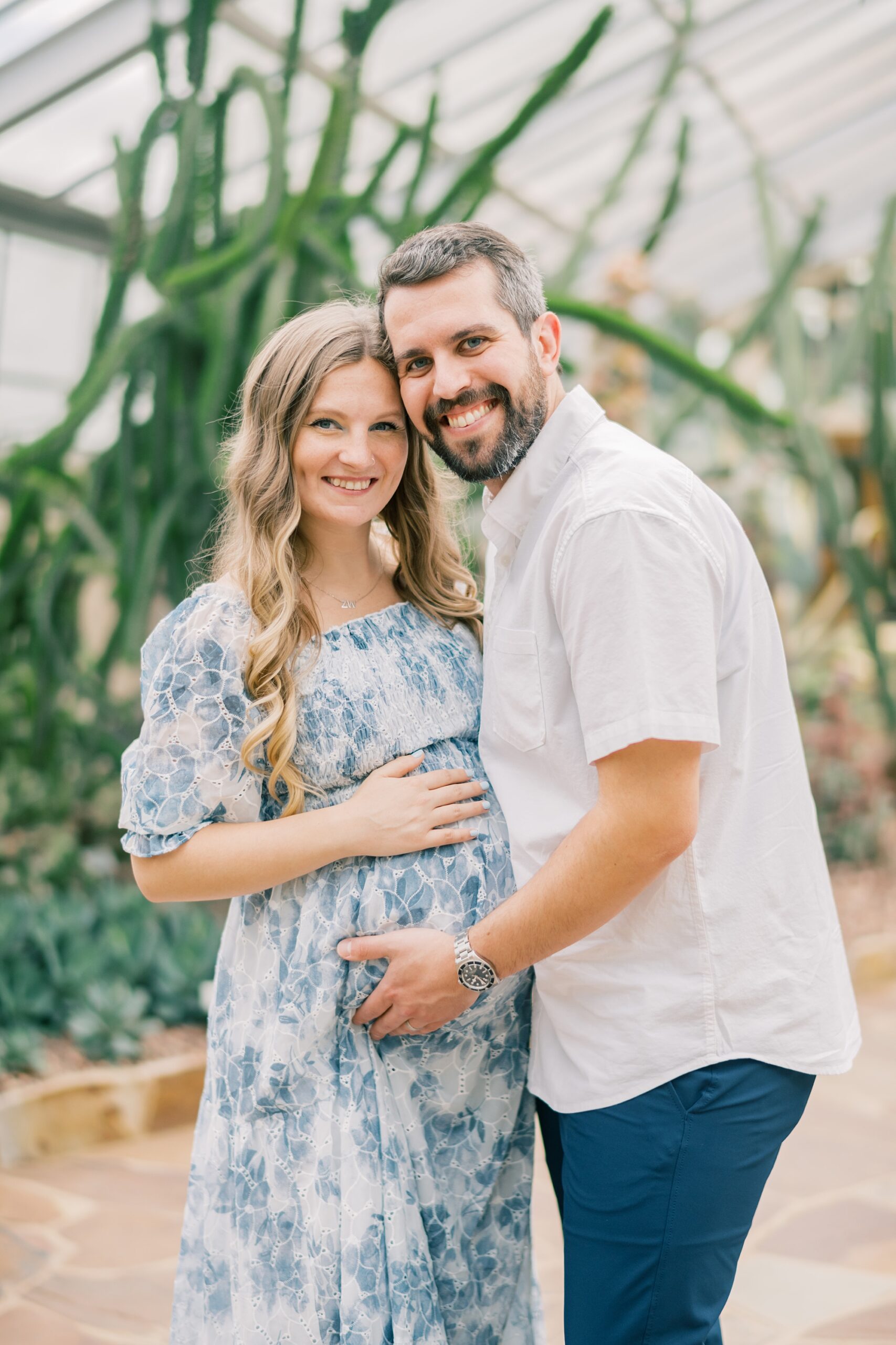 married couple hugs during Rawlings Conservatory maternity portraits 