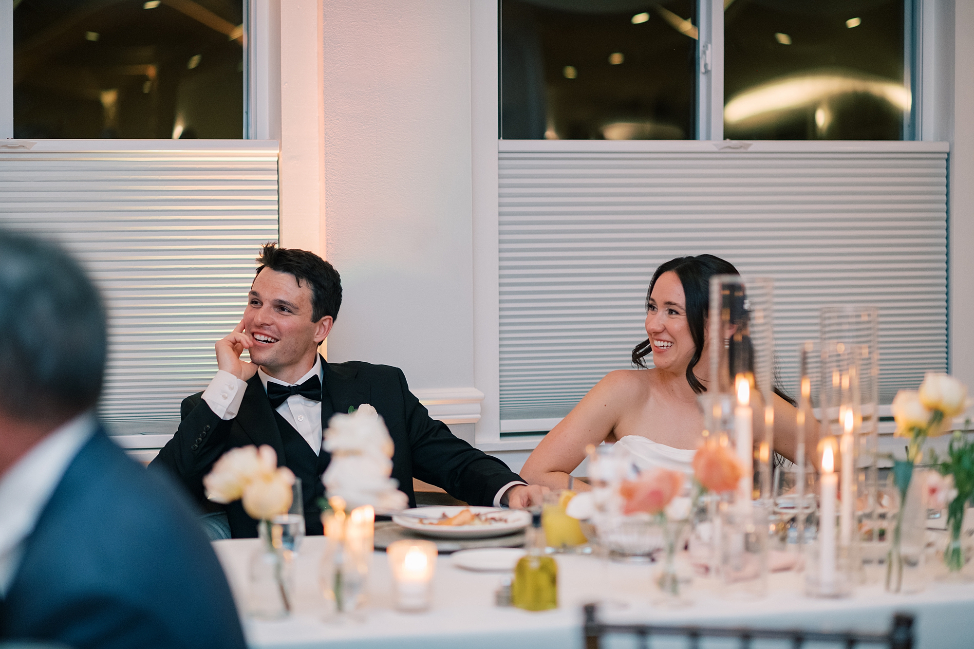 bride and groom listen to speech during North Beach MD wedding reception