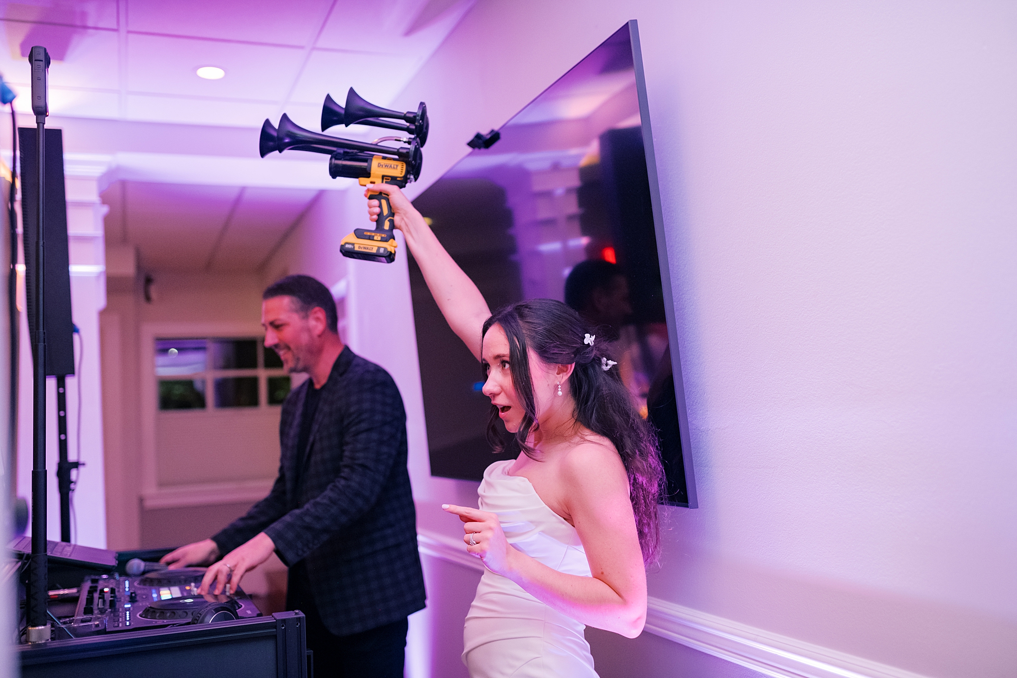 bride holds up air horns during North Beach MD wedding reception