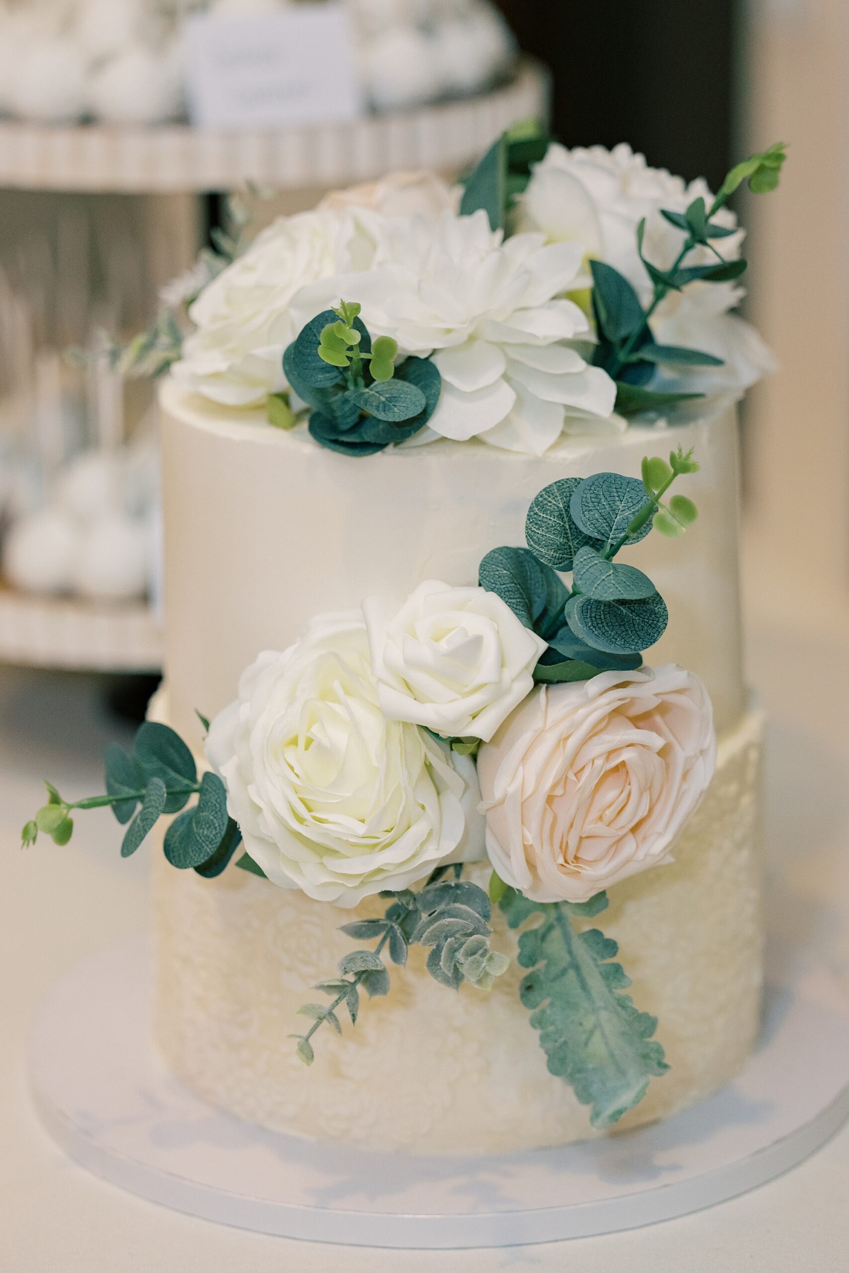 tiered wedding cake with pink  and white roses 