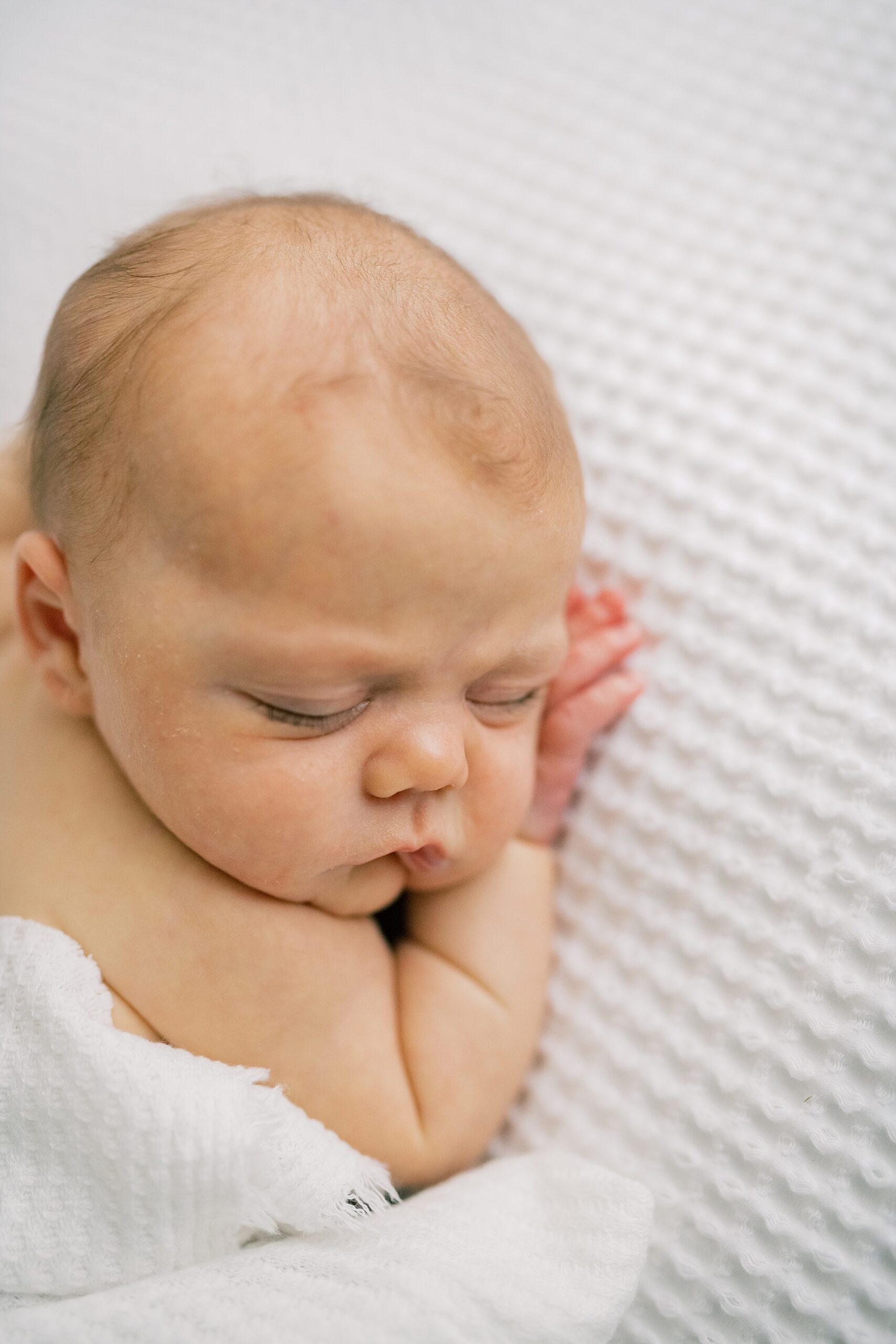 baby girl sleeps during newborn photos in studio