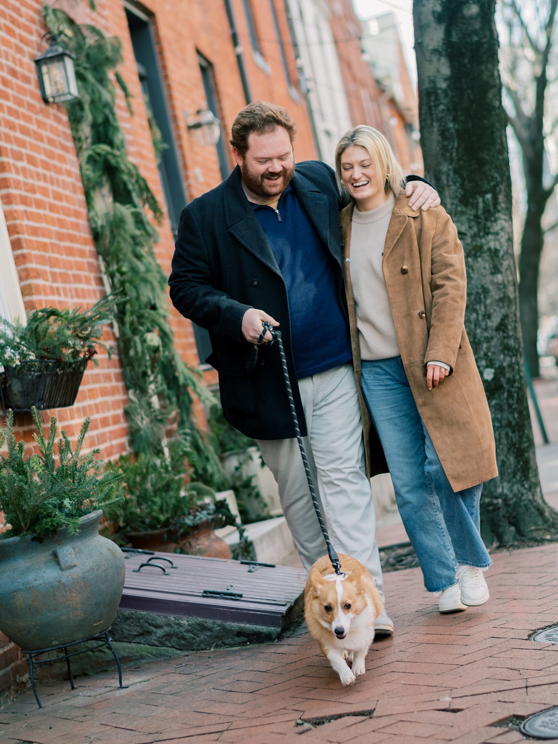 couple walks with dog during Baltimore engagement session