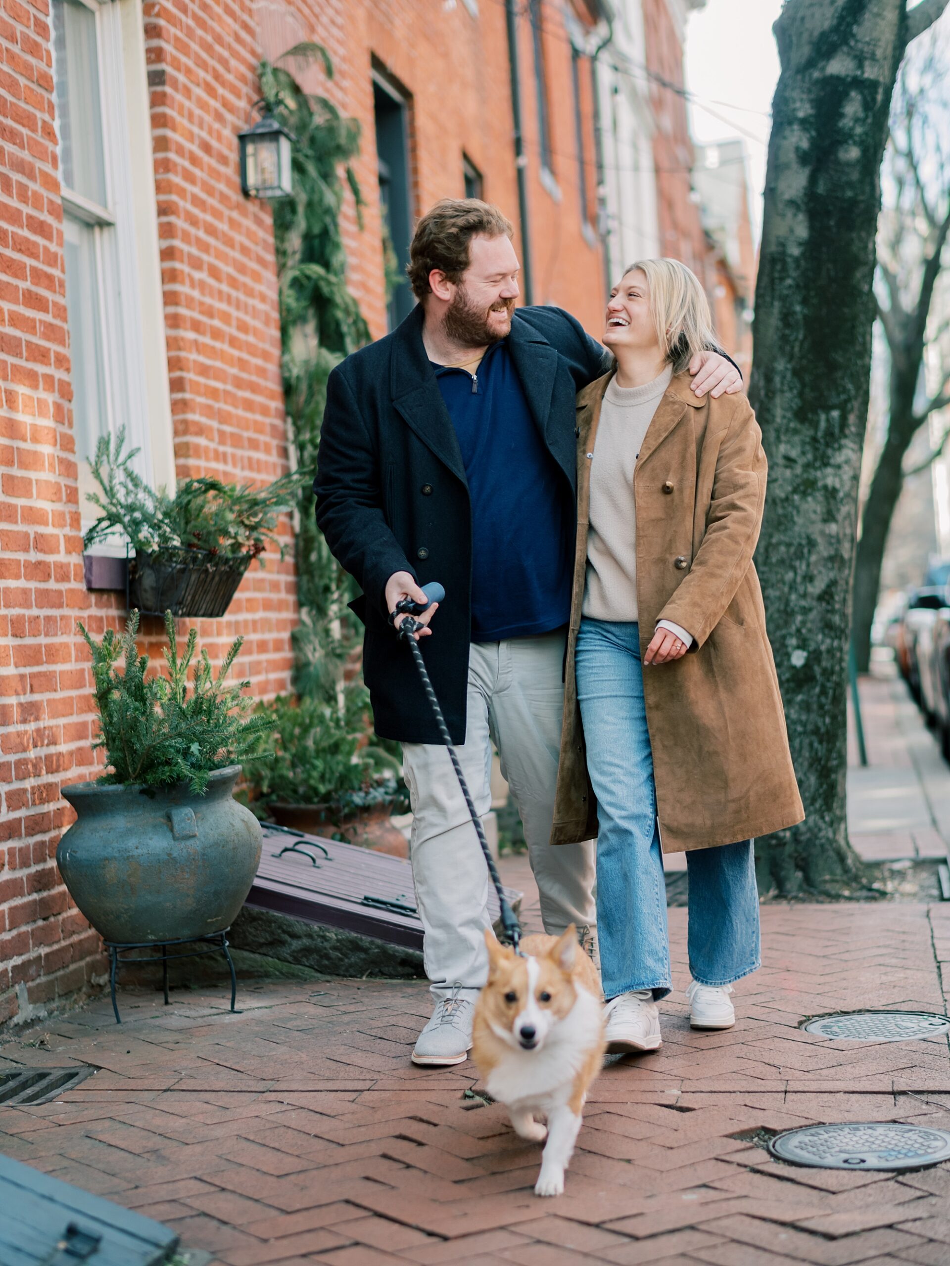 engaged couple walks dog during winter Baltimore engagement session