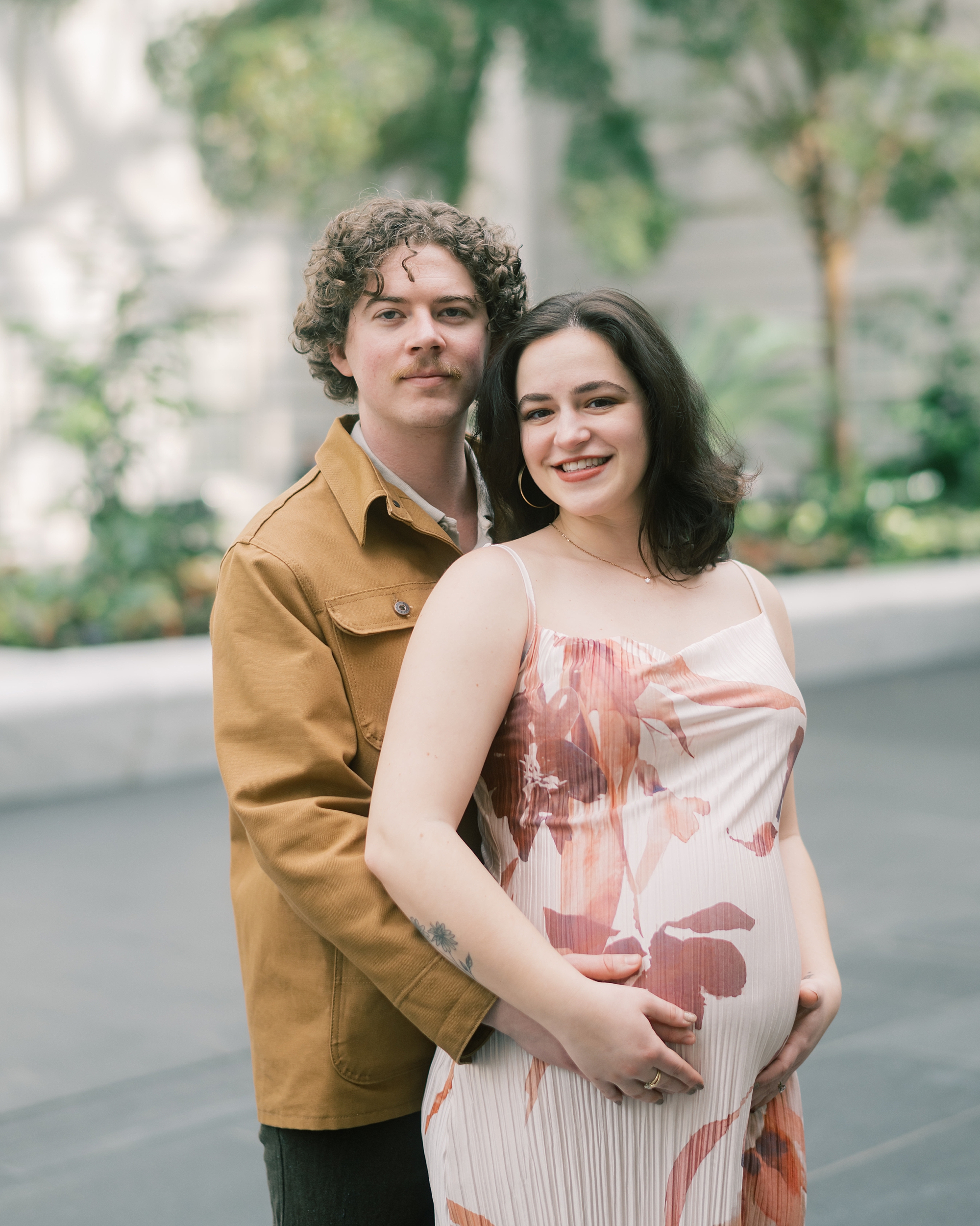 man hugs woman from behind during maternity session in Washington DC
