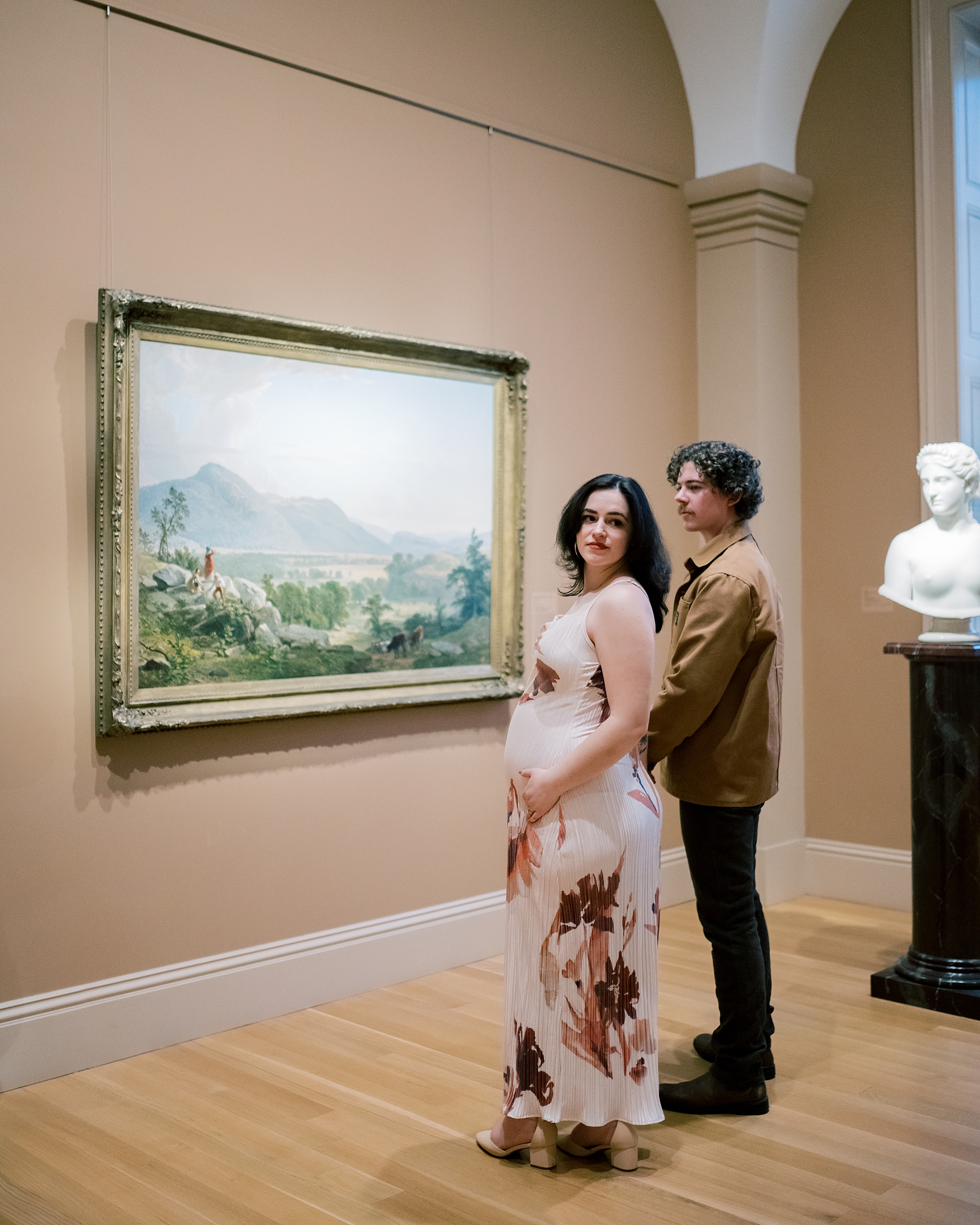 man stands behind woman hugging her baby bump during maternity session in Washington DC