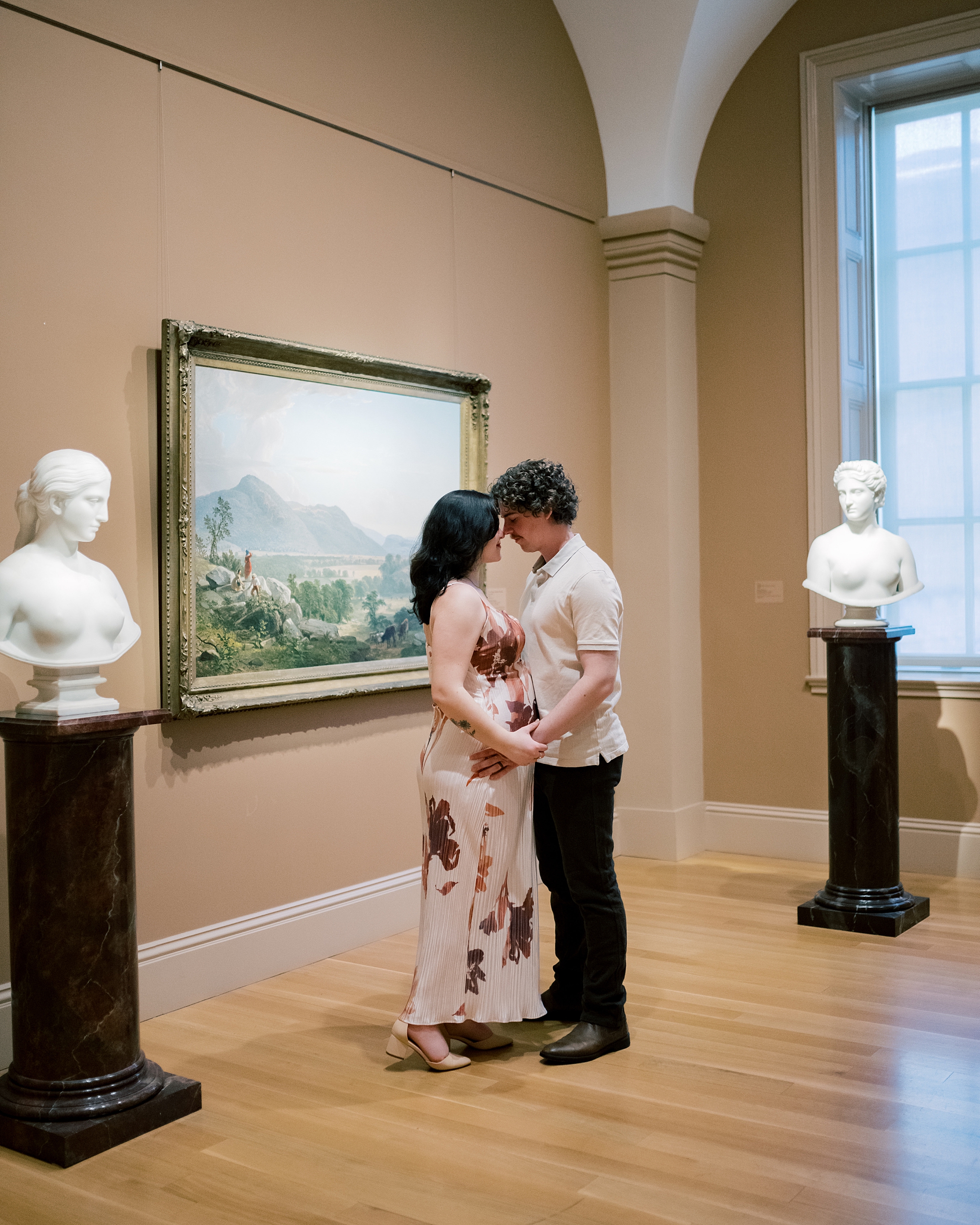 couple stands together touching foreheads in gallery in Washington DC