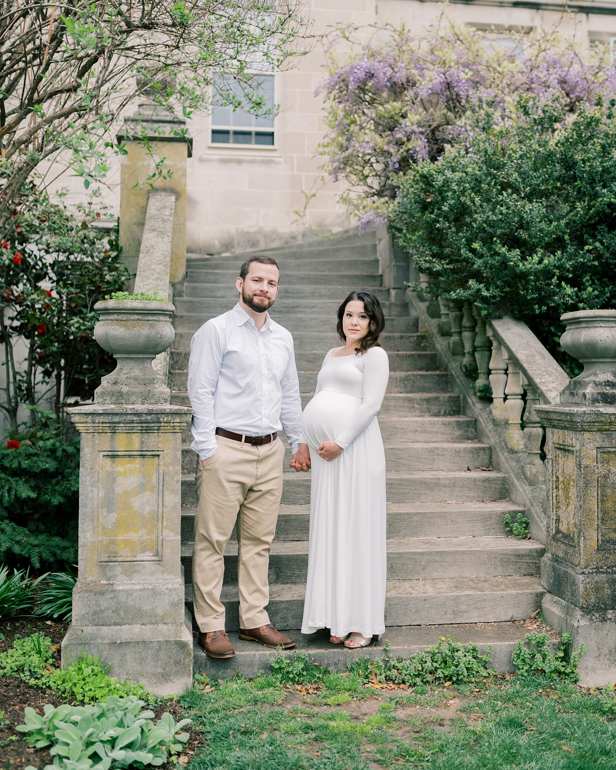 man and woman stand on steps of the Washington National Cathedral