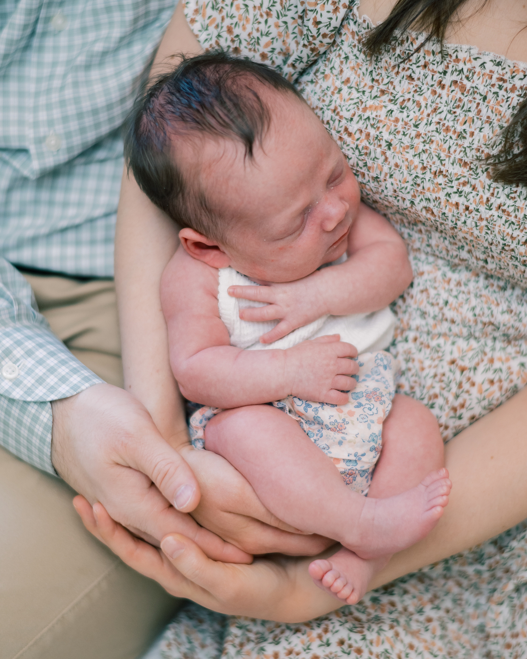 parents snuggle with newborn baby girl during newborn session at home in Washington DC