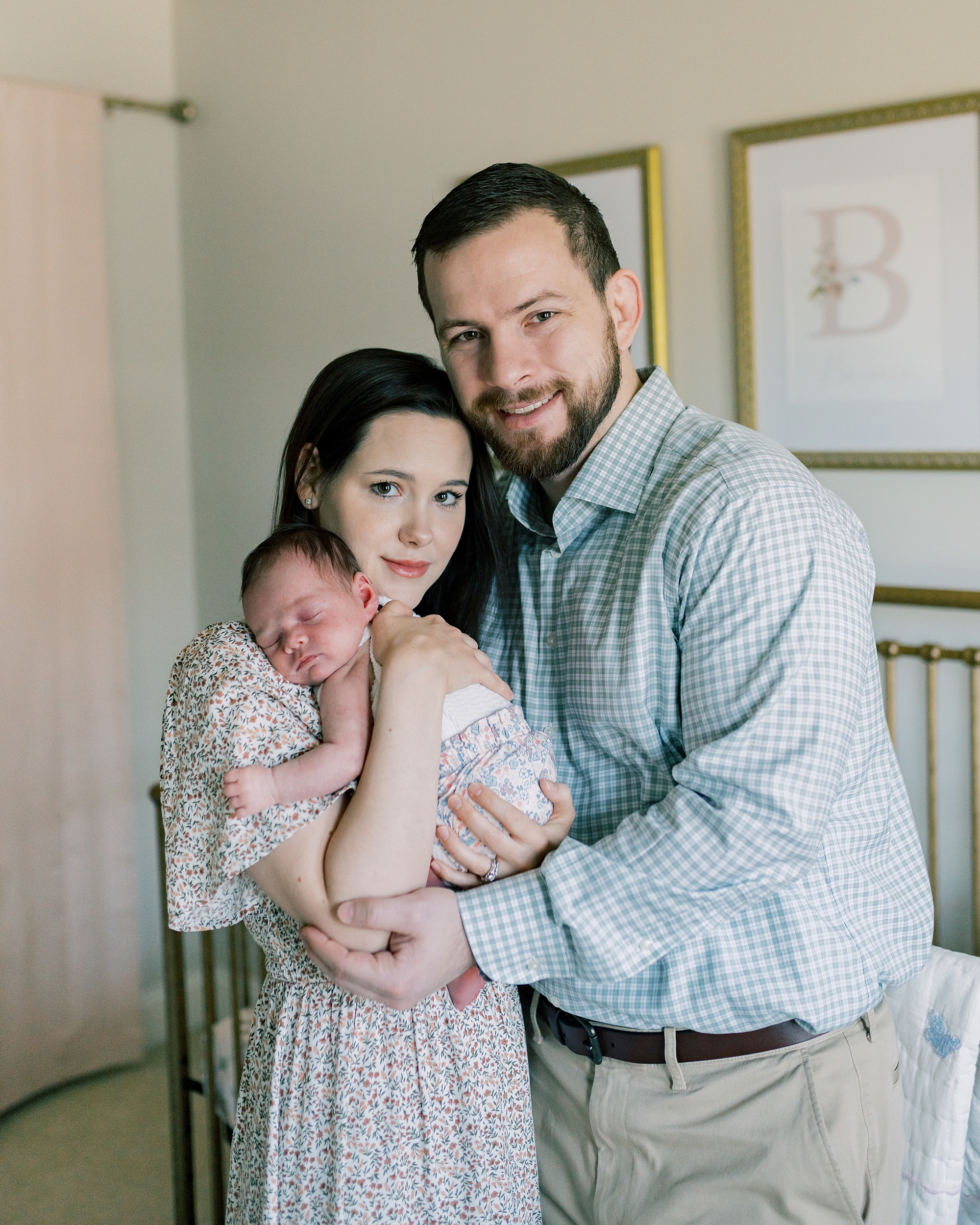 parents stand holding newborn baby girl during photos in Washington DC