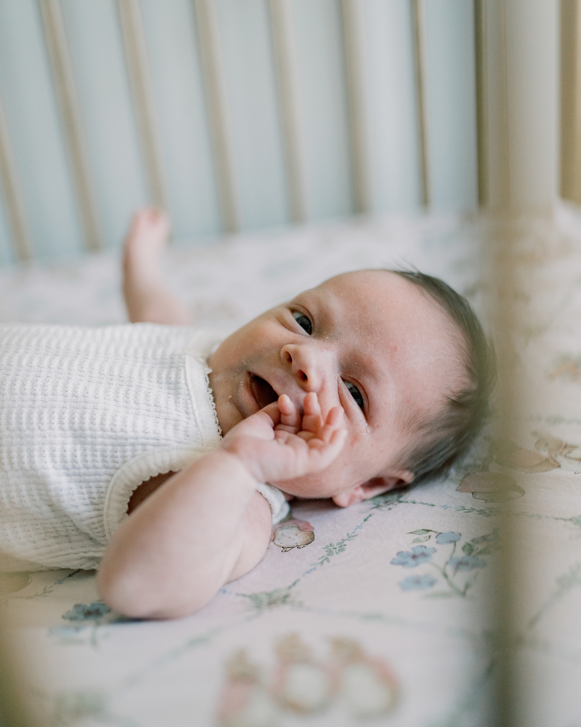 baby lays on Peter Rabbit sheets during newborn session at home in Washington DC