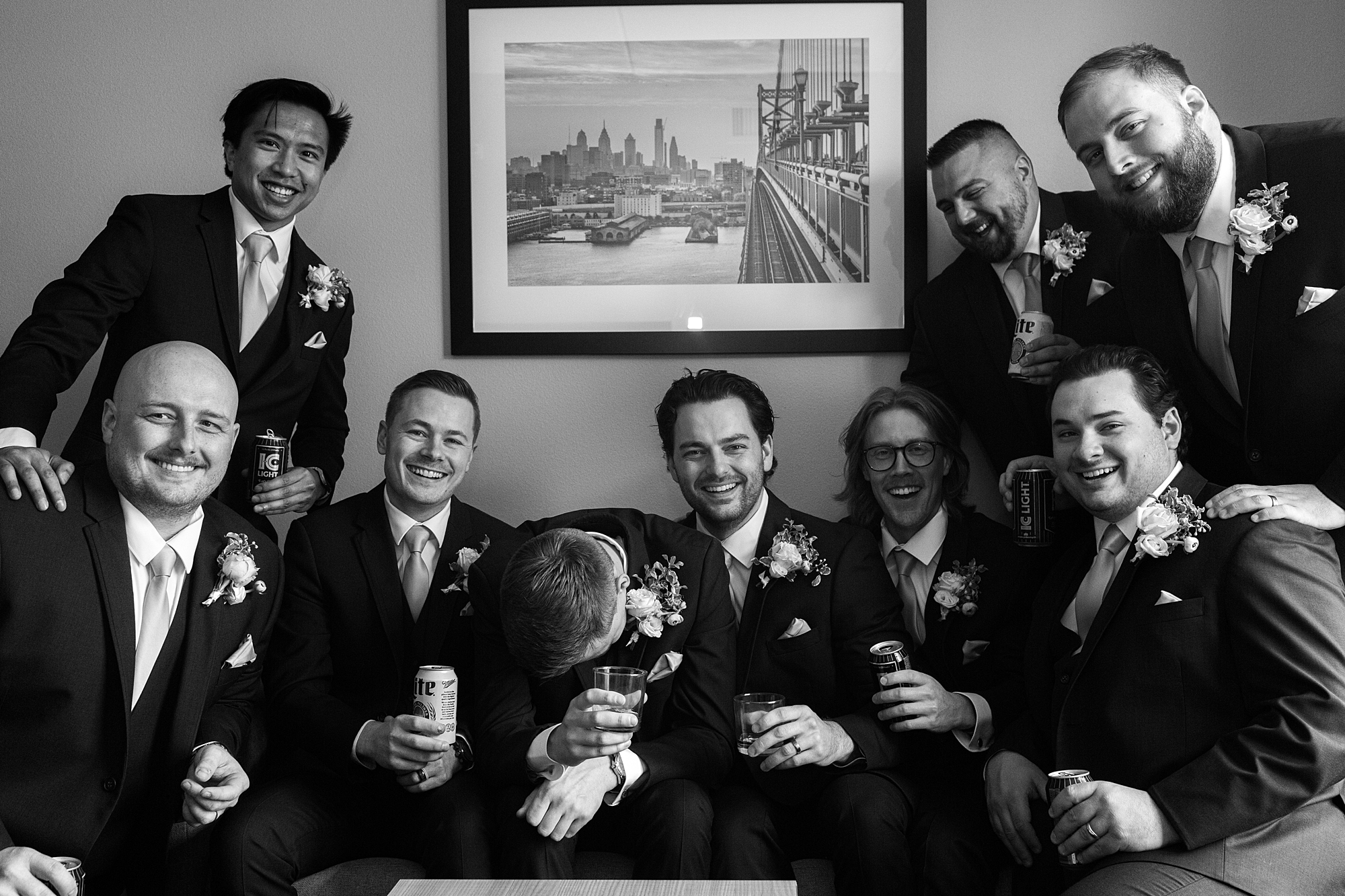 groom and groomsmen sit in Pennsylvania hotel room