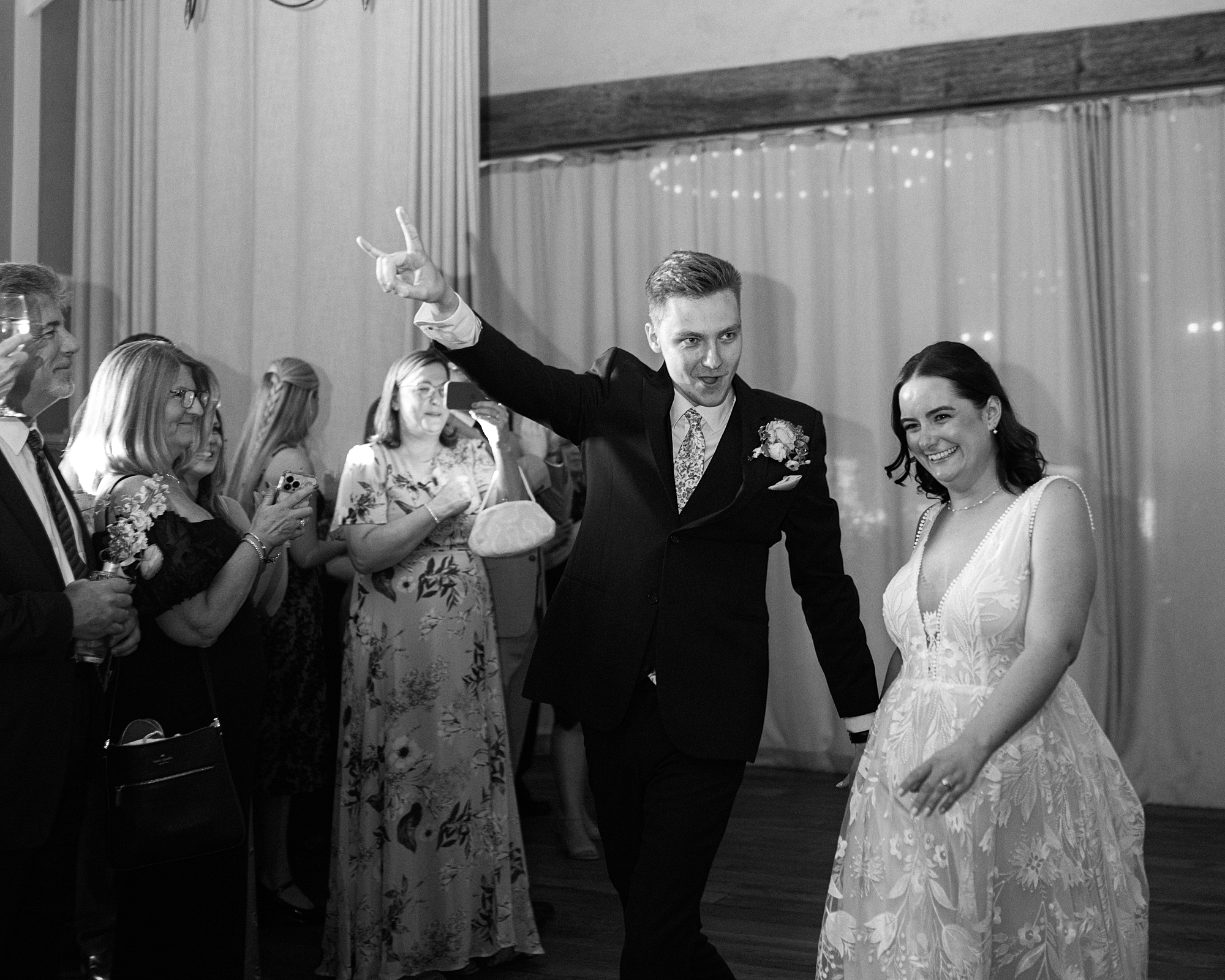 bride and groom cheer walking into reception at Terrain Gardens